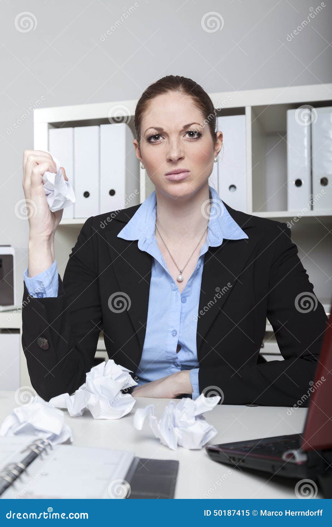 angry employee crushing paper