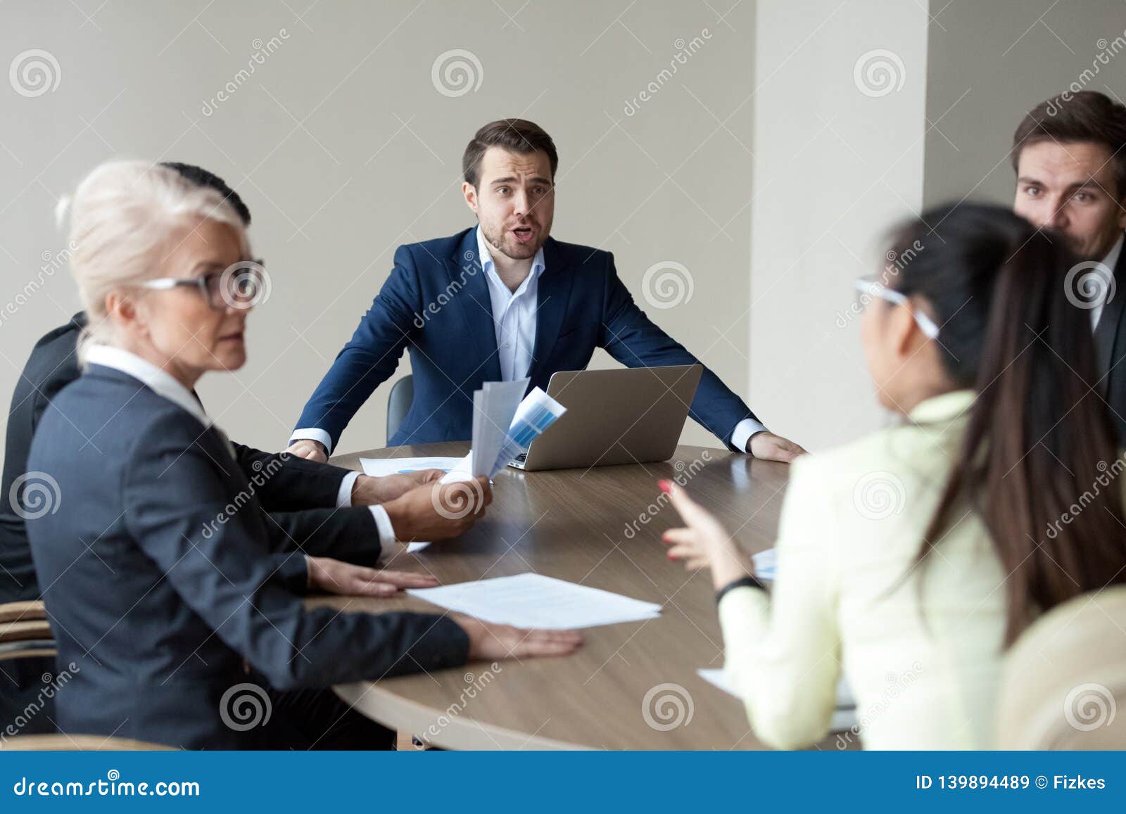 angry executive shouting having disagreement with employee at group meeting