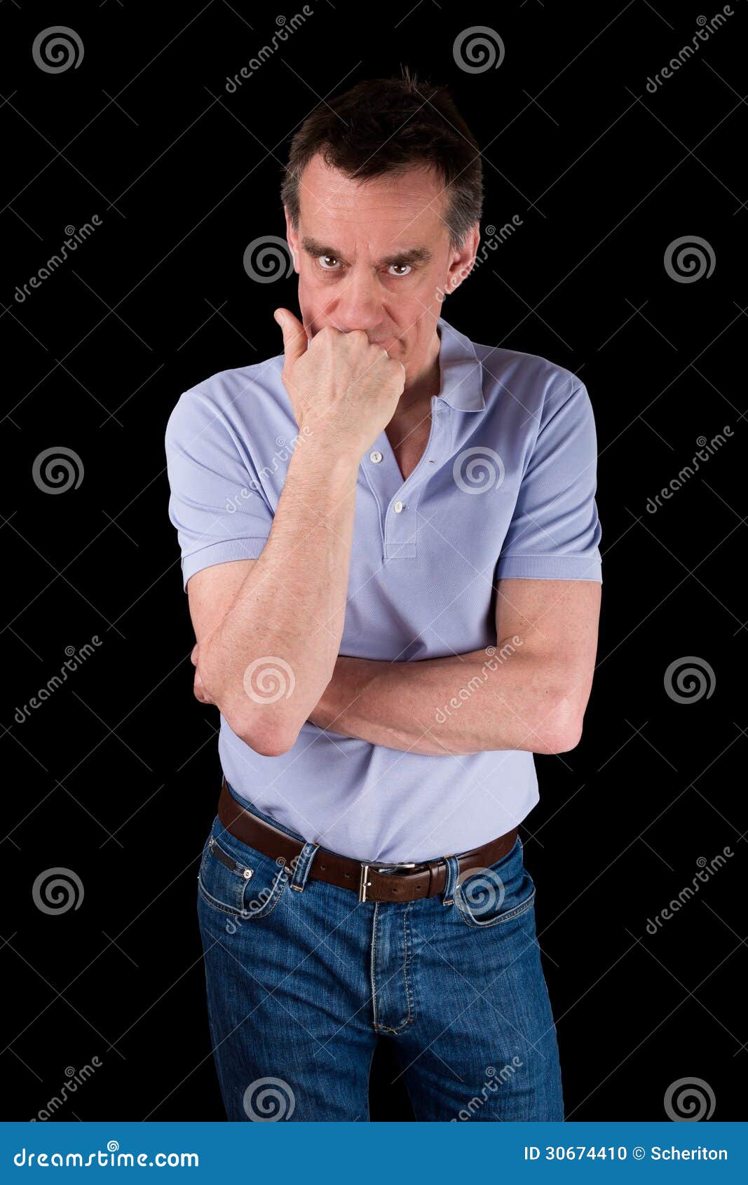 angry frowning man glaring over hand on chin