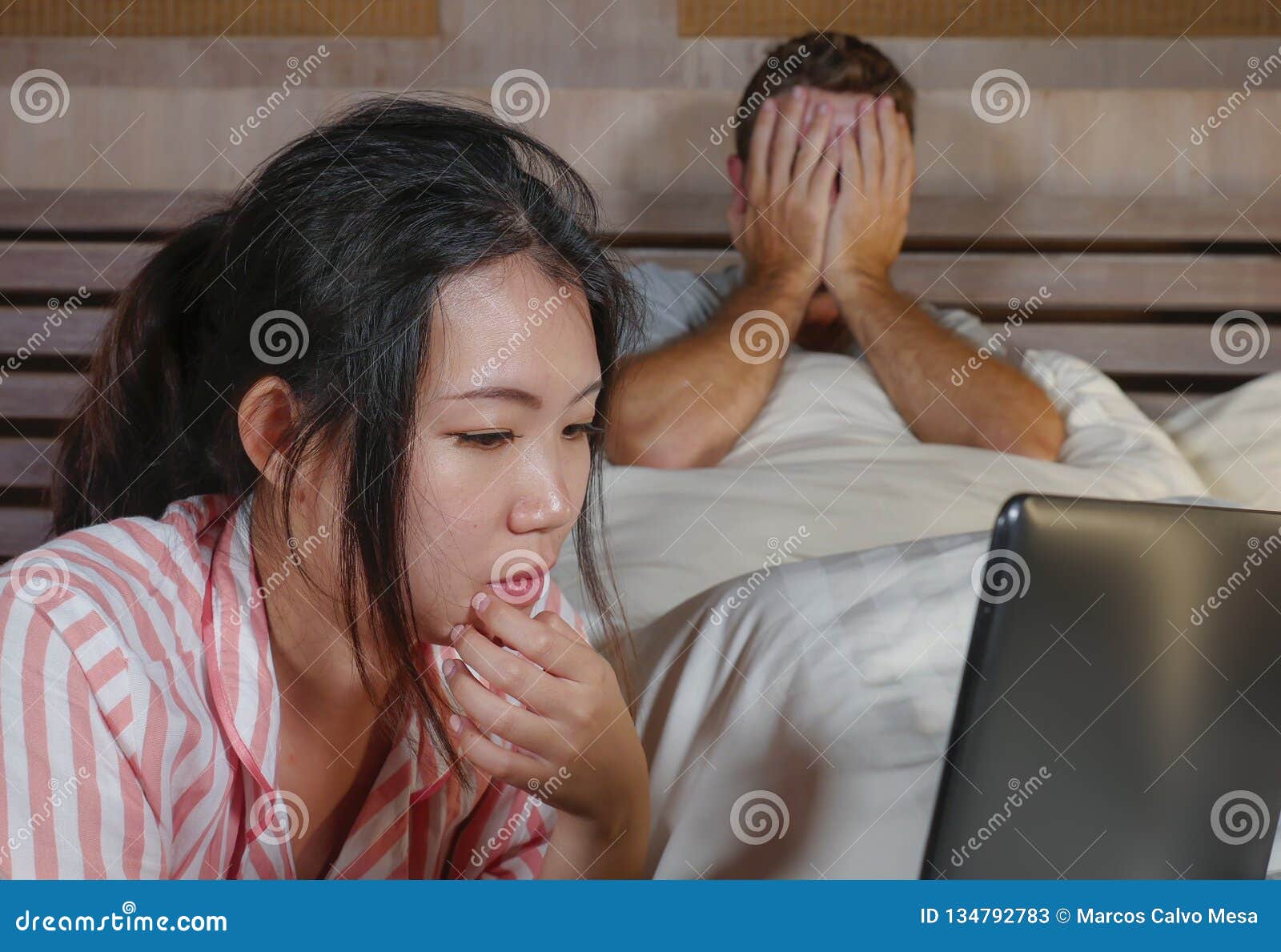 Frustrated Husband Moody In Bed Ignored By His Workaholic Asian Wife Or