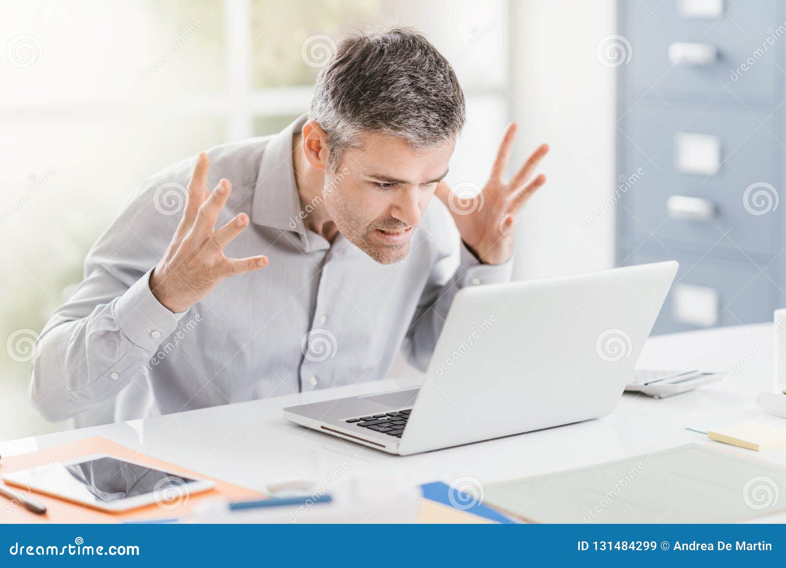 angry frustrated office worker having problems with his laptop and connection, computer problems and troubleshooting concept