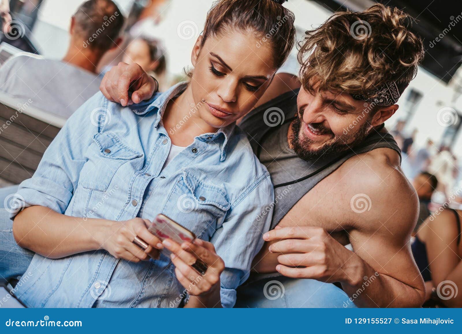 Angry Girlfriend Showing Mobile Phone To Her Boyfriend Stoc photo