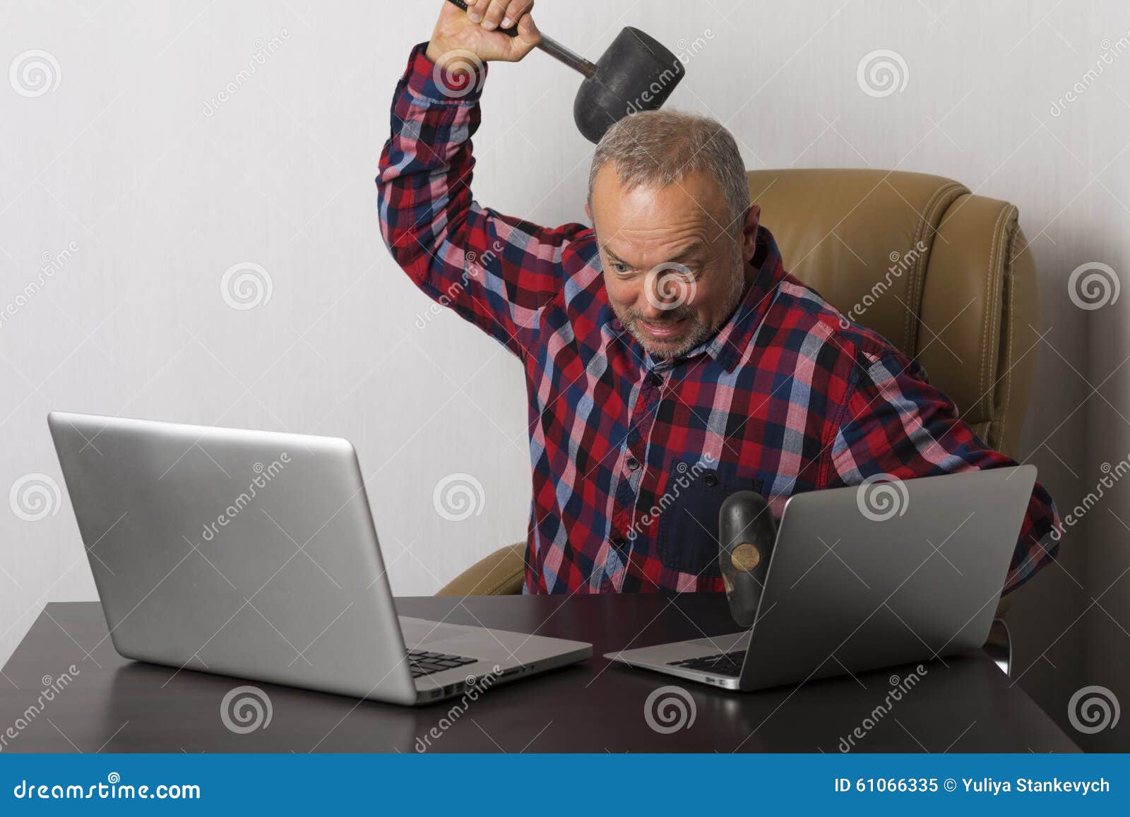 Angry man crashing laptop stock image. Image of indor 61066335