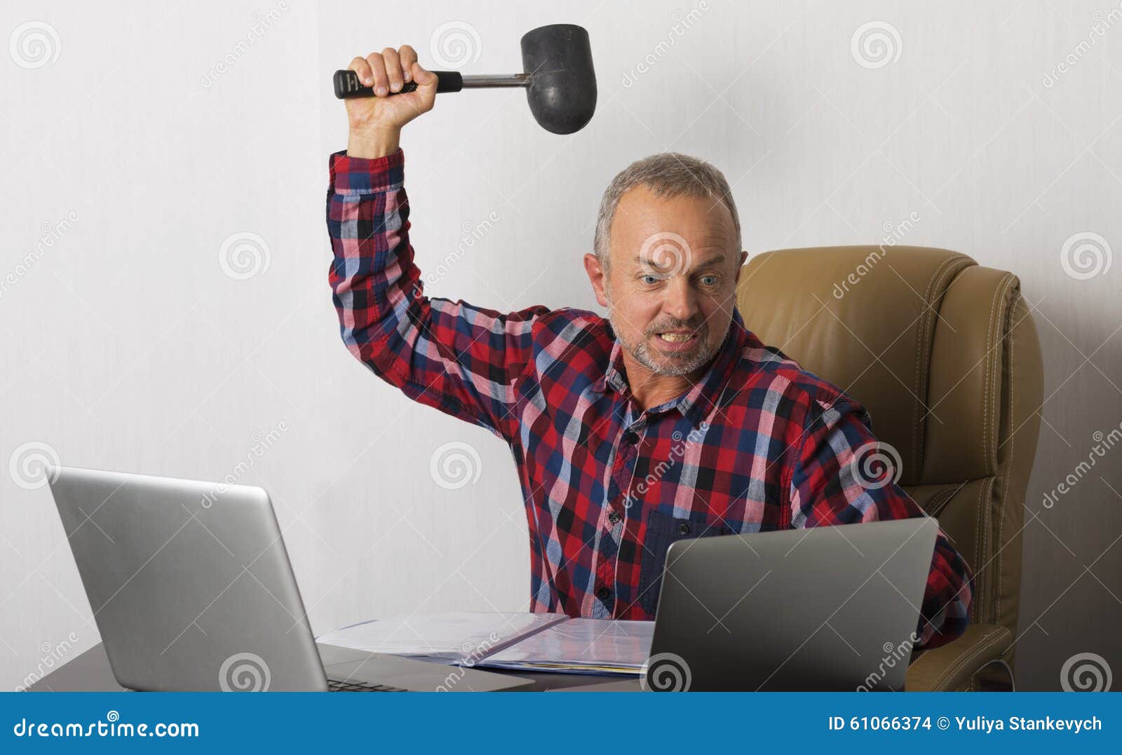 Angry man crashing laptop stock photo. Image of checked 61066374