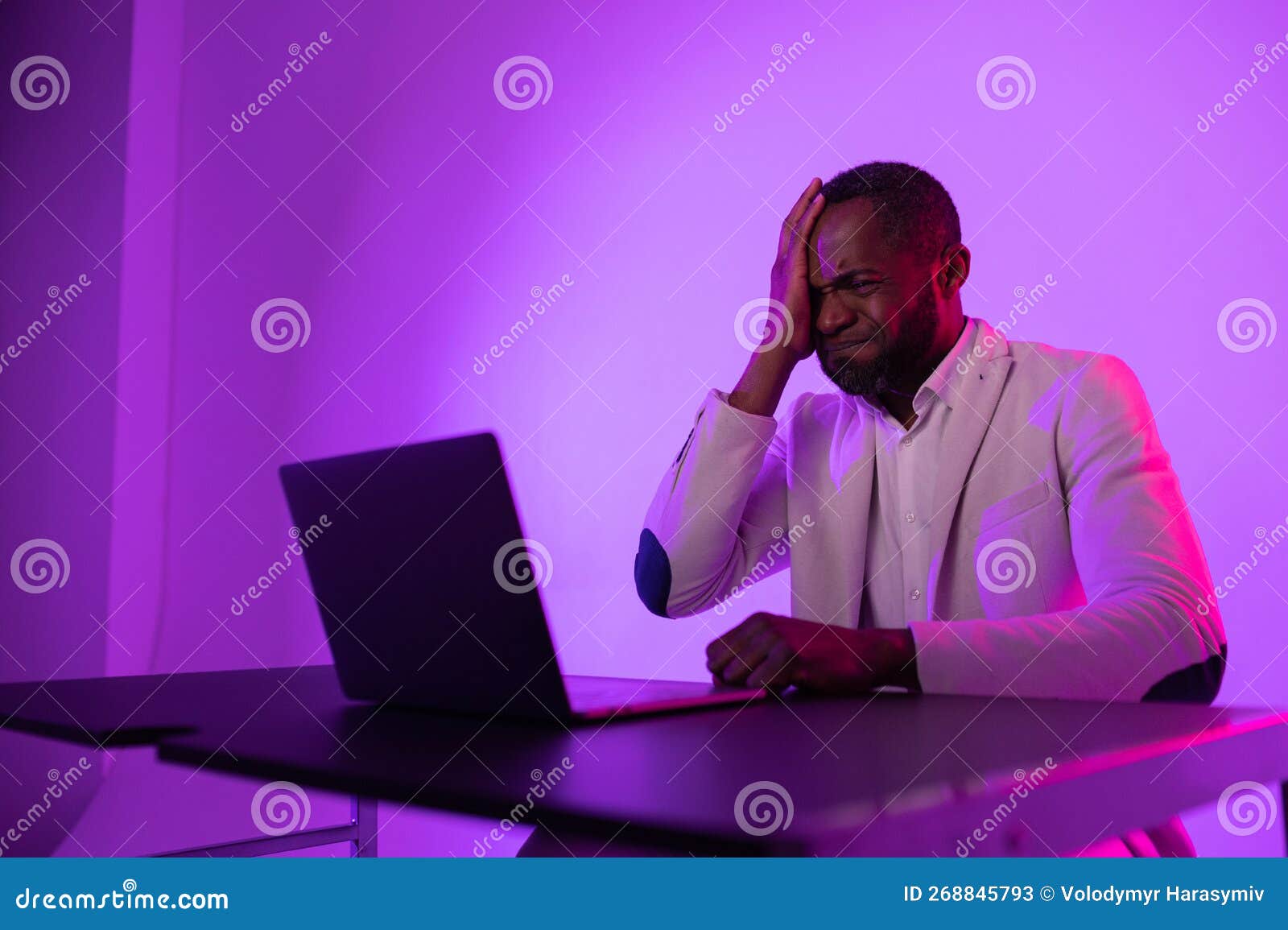 Angry Man at Work. Angry African American Worker Looking at Laptop