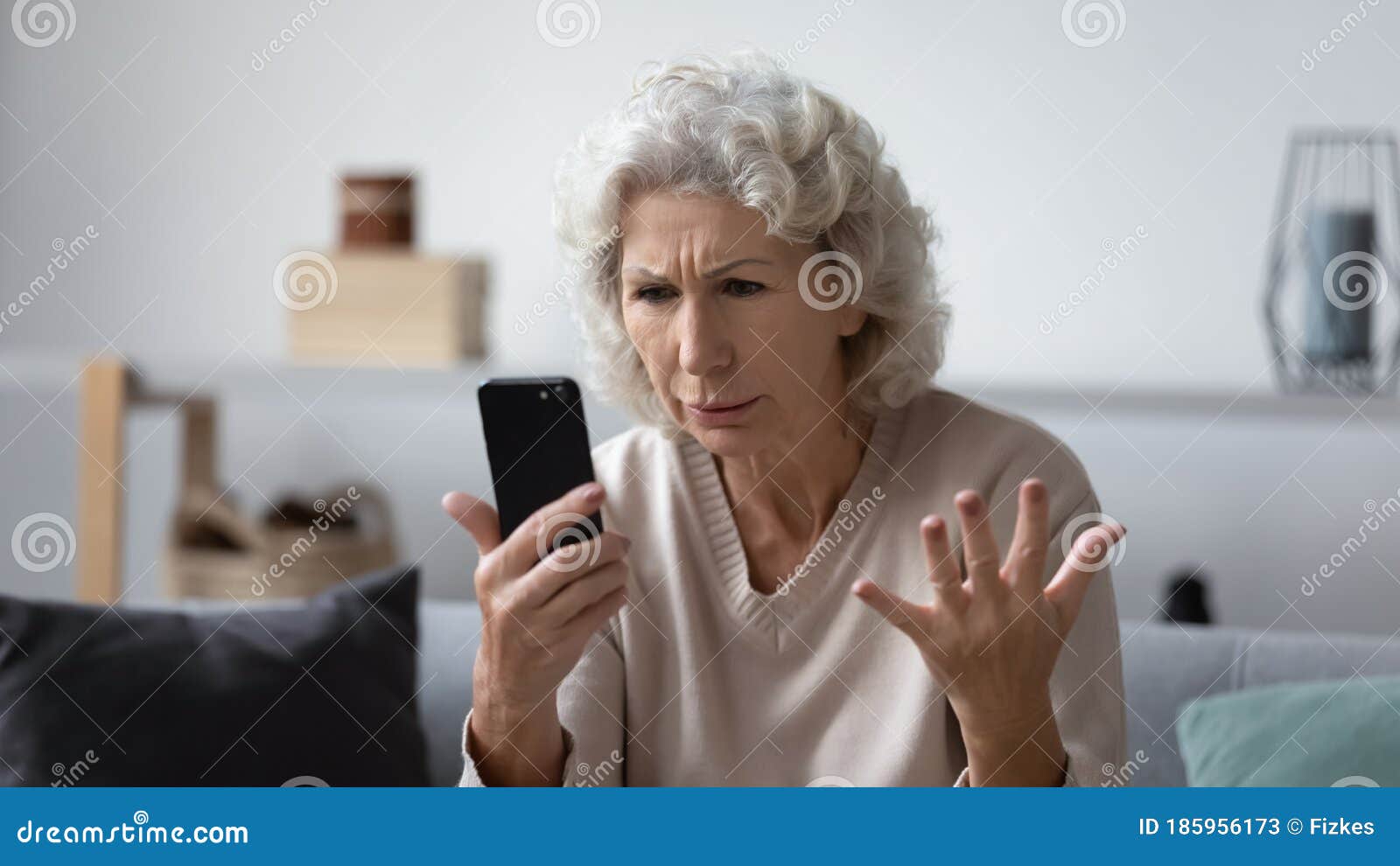 angry senior woman frustrated by smartphone problems
