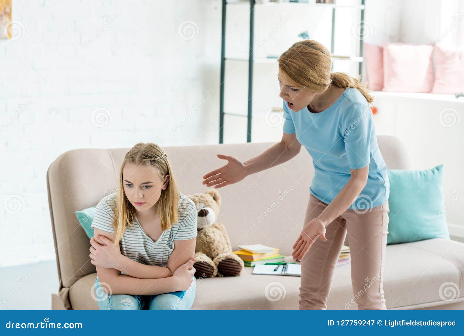 angry mother yelling at teen daughter