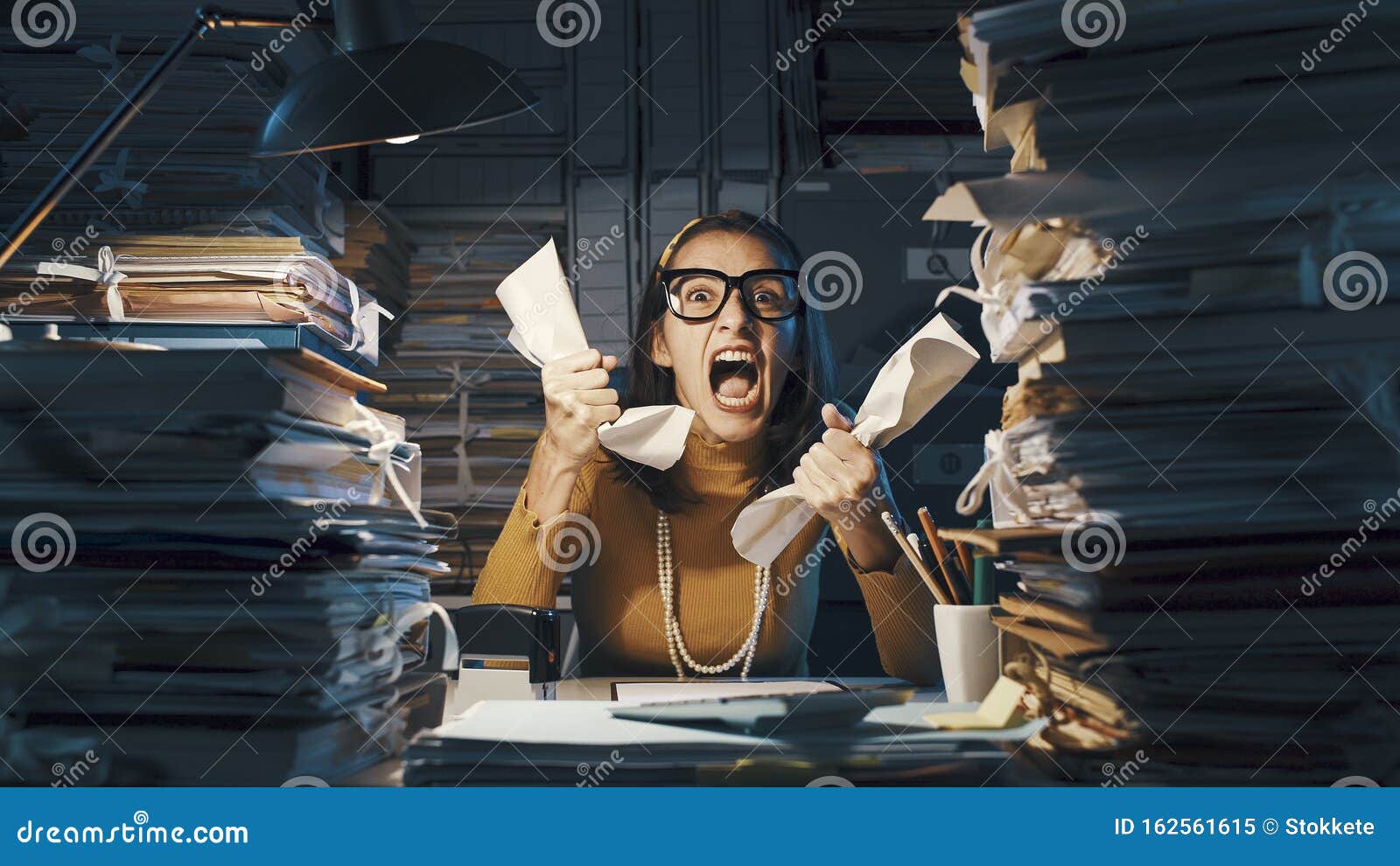 angry stressed office worker overloaded with paperwork