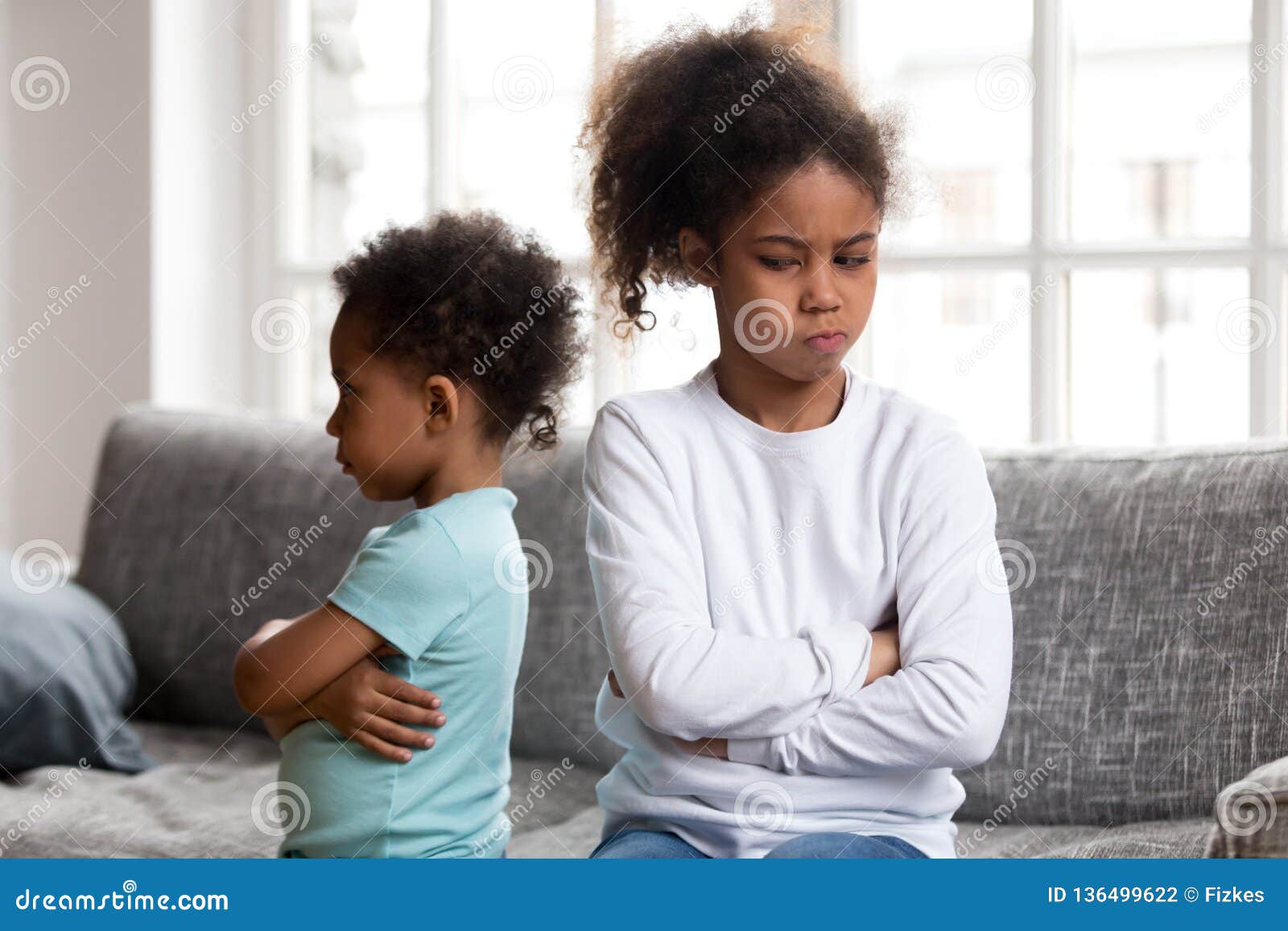 angry stubborn african sister and offended brother ignoring each