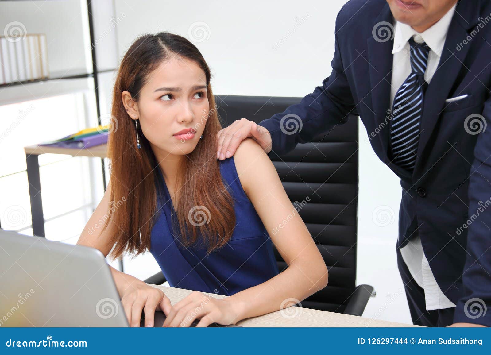 Angry Unhappy Asian Secretary Woman Looking Hand`s Boss Touching Her Shoulder In Workplace