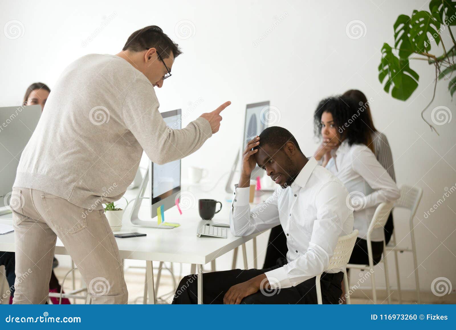 angry white boss scolding rebuking incompetent black employee in