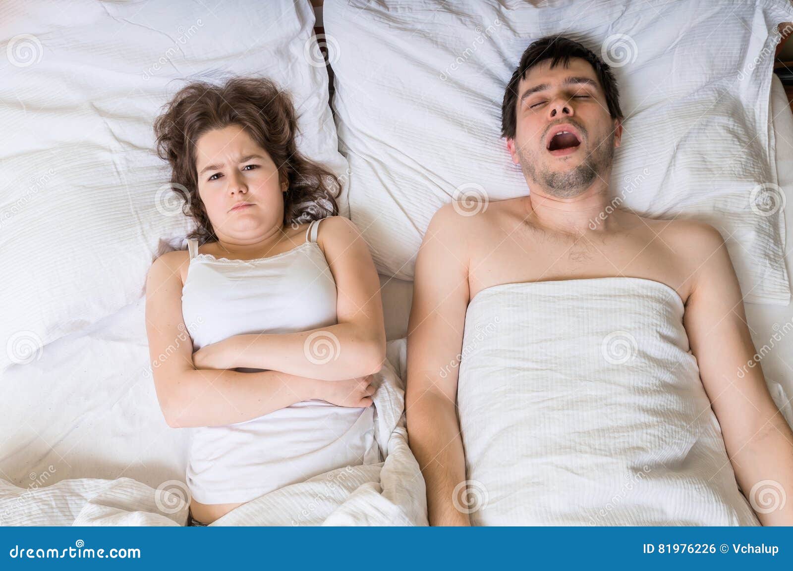 angry woman cant sleep and listening her husband snoring