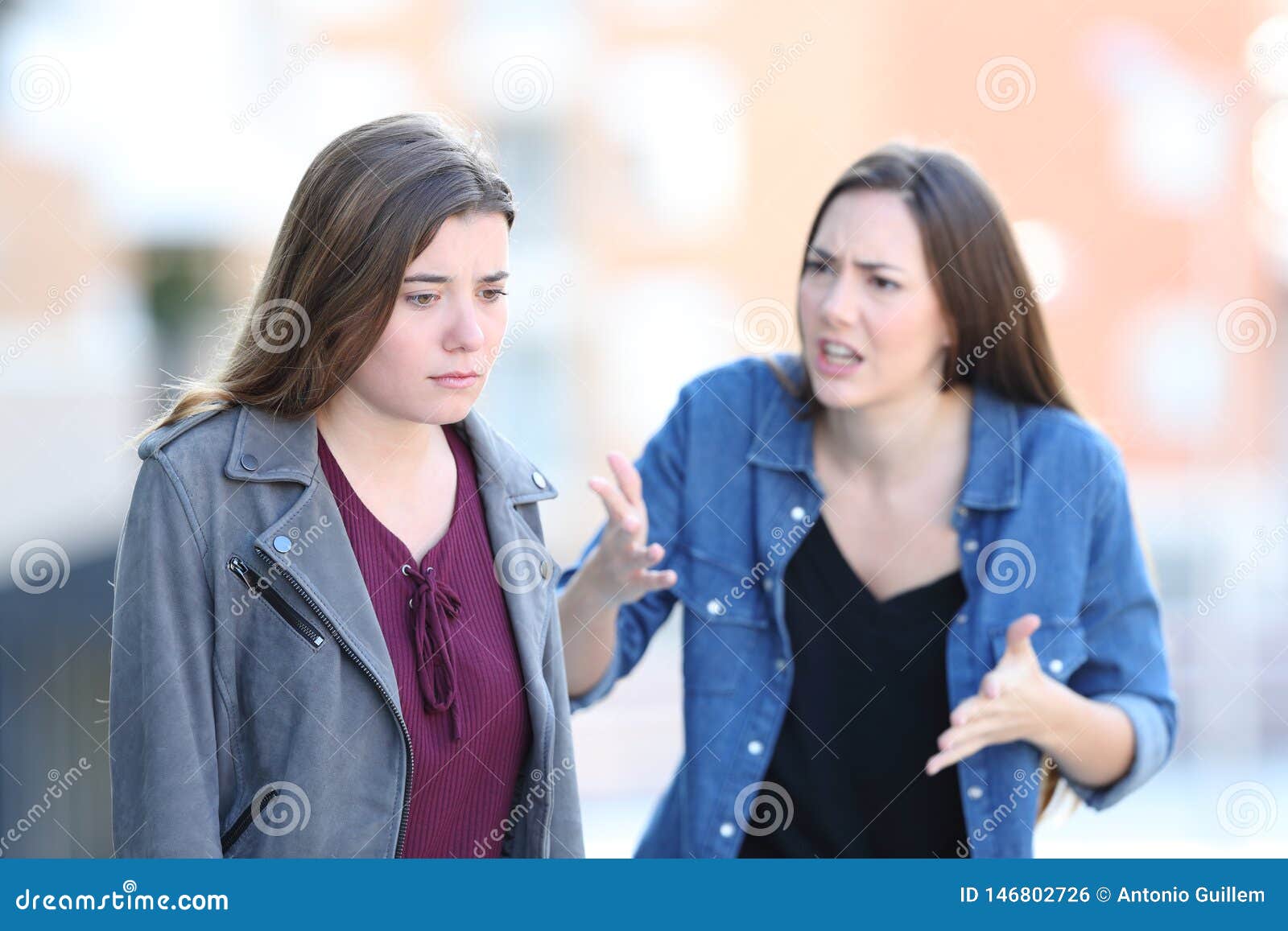 angry woman scolding her guilty friend