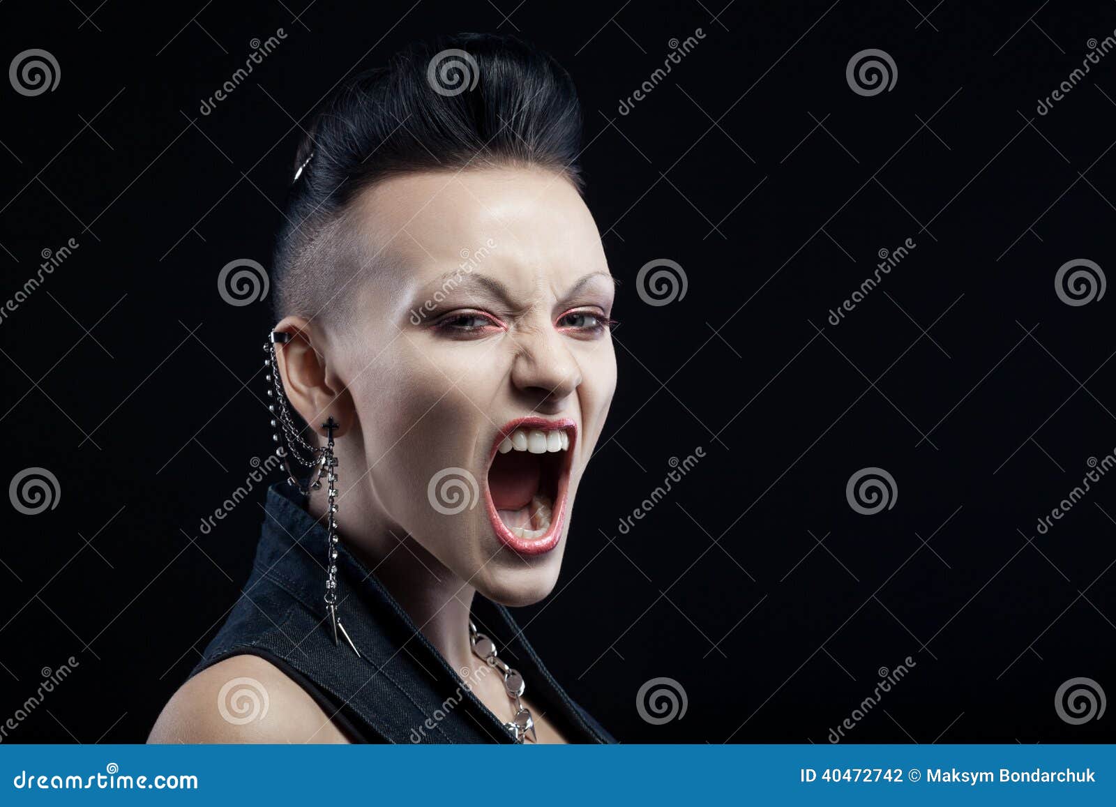 angry young woman screaming  on black background