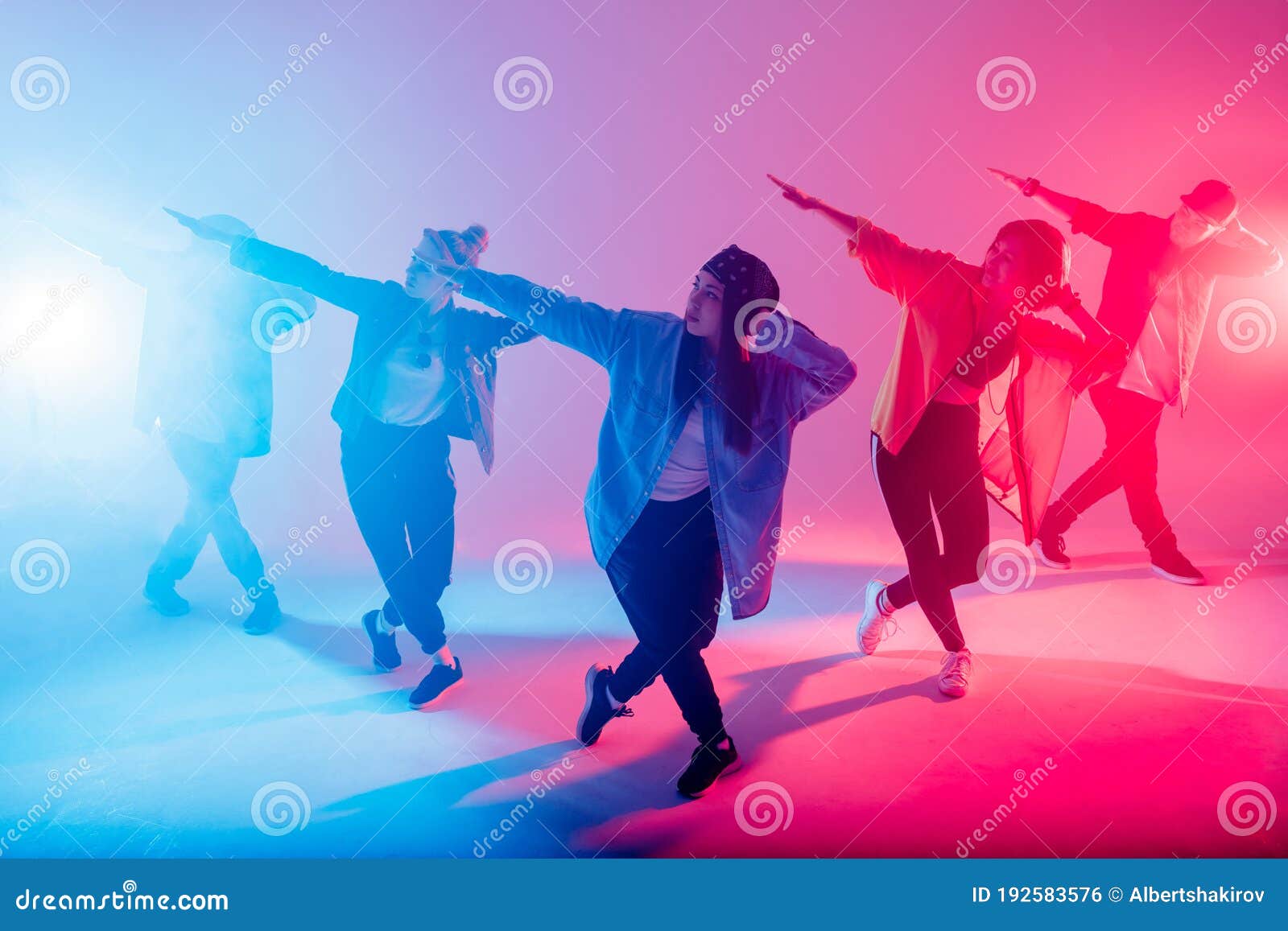 diverse group of people dancing in studio with red and blue dual color light