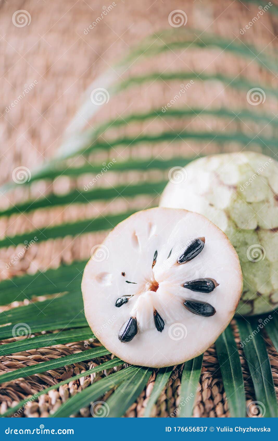 annona muricata or soursop, graviola and guyabano with palm leaves on rattan background. copy space. creative  banner.