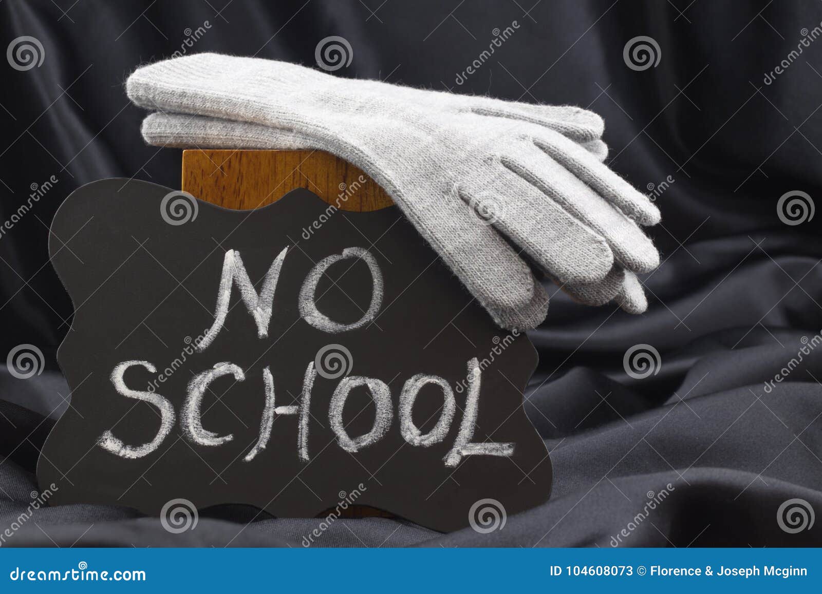 no school sign on chalkboard against black satin warns of cold w
