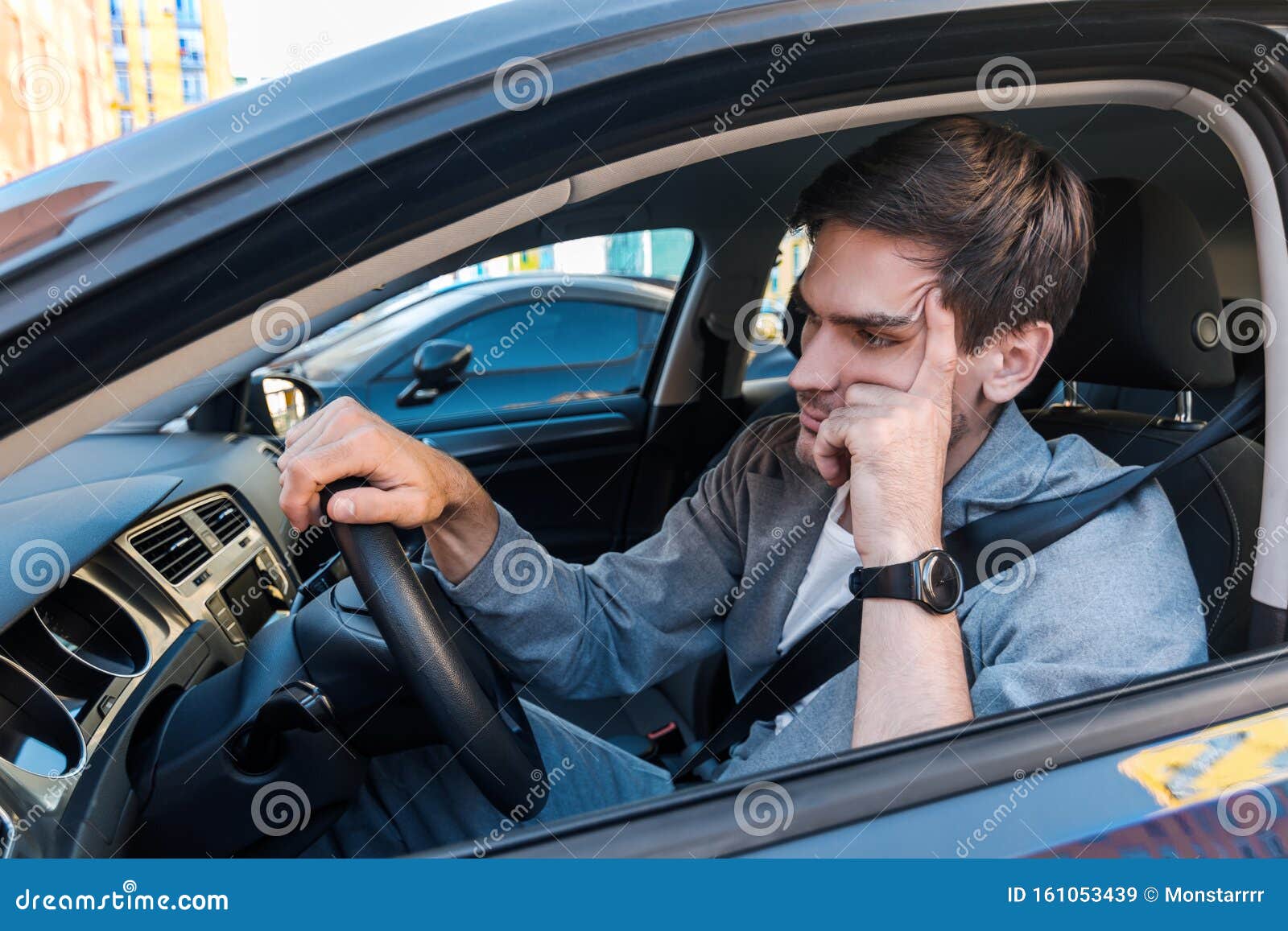 annoyed businessman in car stuck in traffic jam