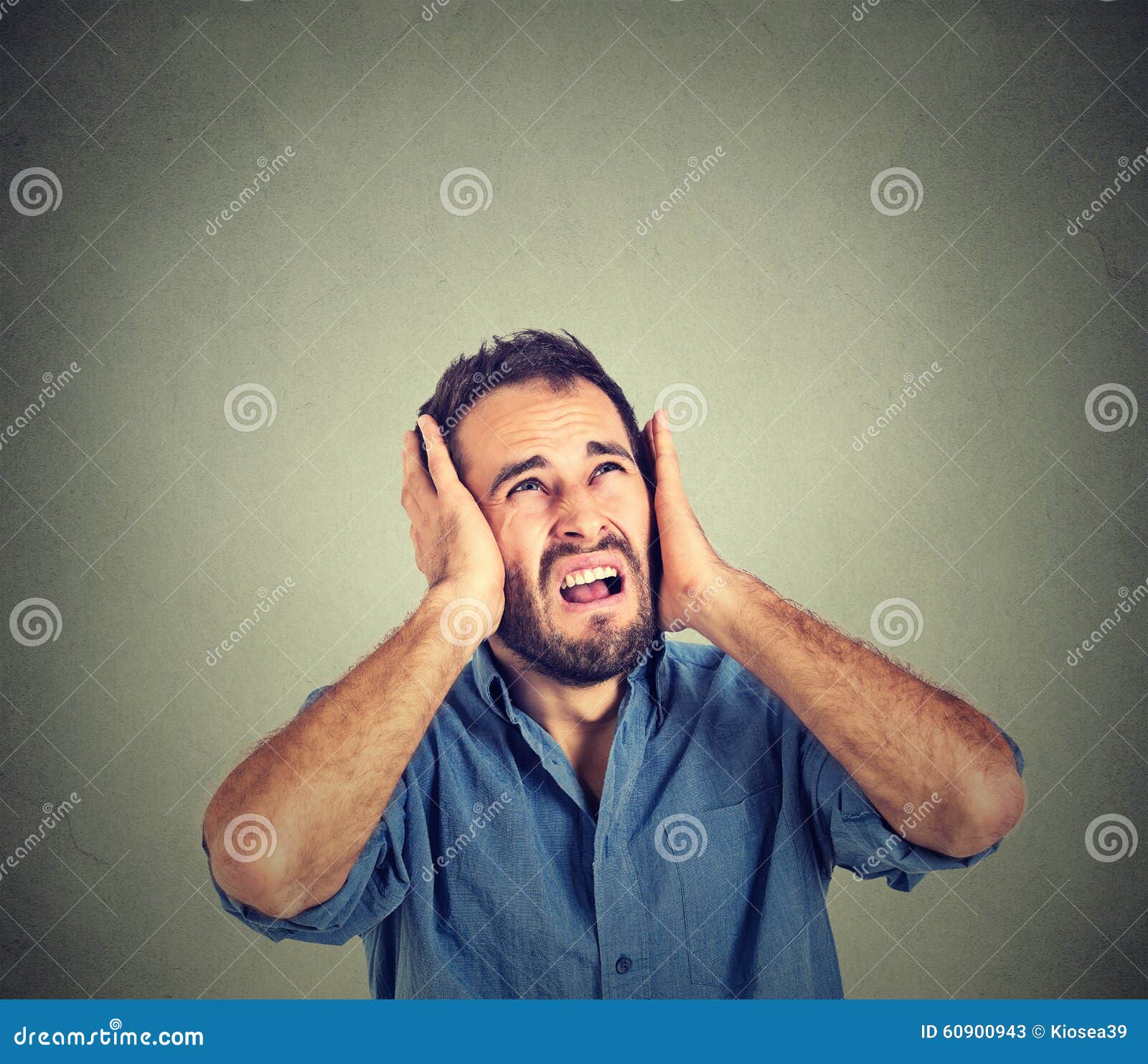 annoyed, stressed man covering his ears, looking up, stop making loud noise