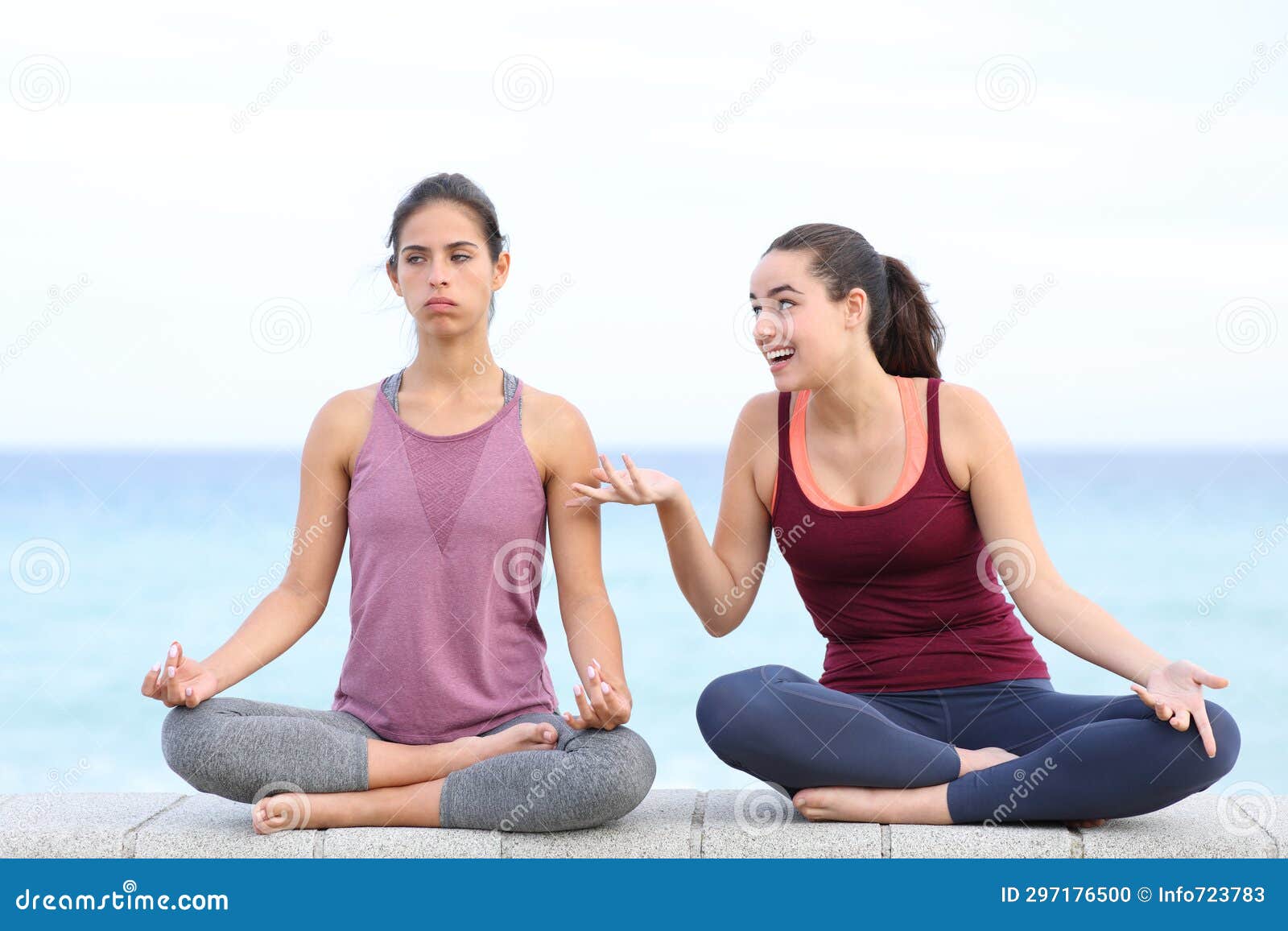 annoyed yogi trying to do yoga with a friend disturbing