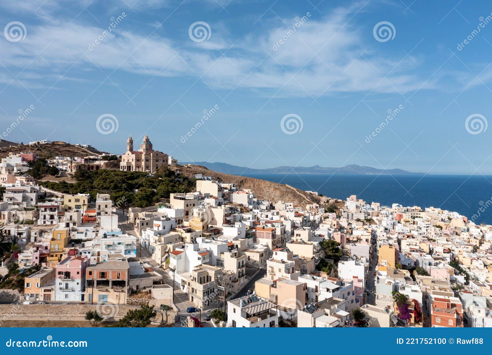 syros island, greece, aerial drone view. ermoupolis and ano siros town cityscape, cloudy blue sky background