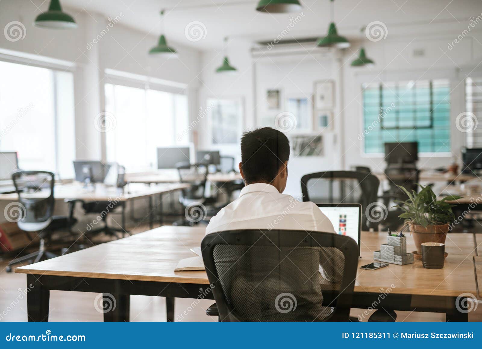 Anonymous Business Person Working On A Laptop At Office Desk Stock