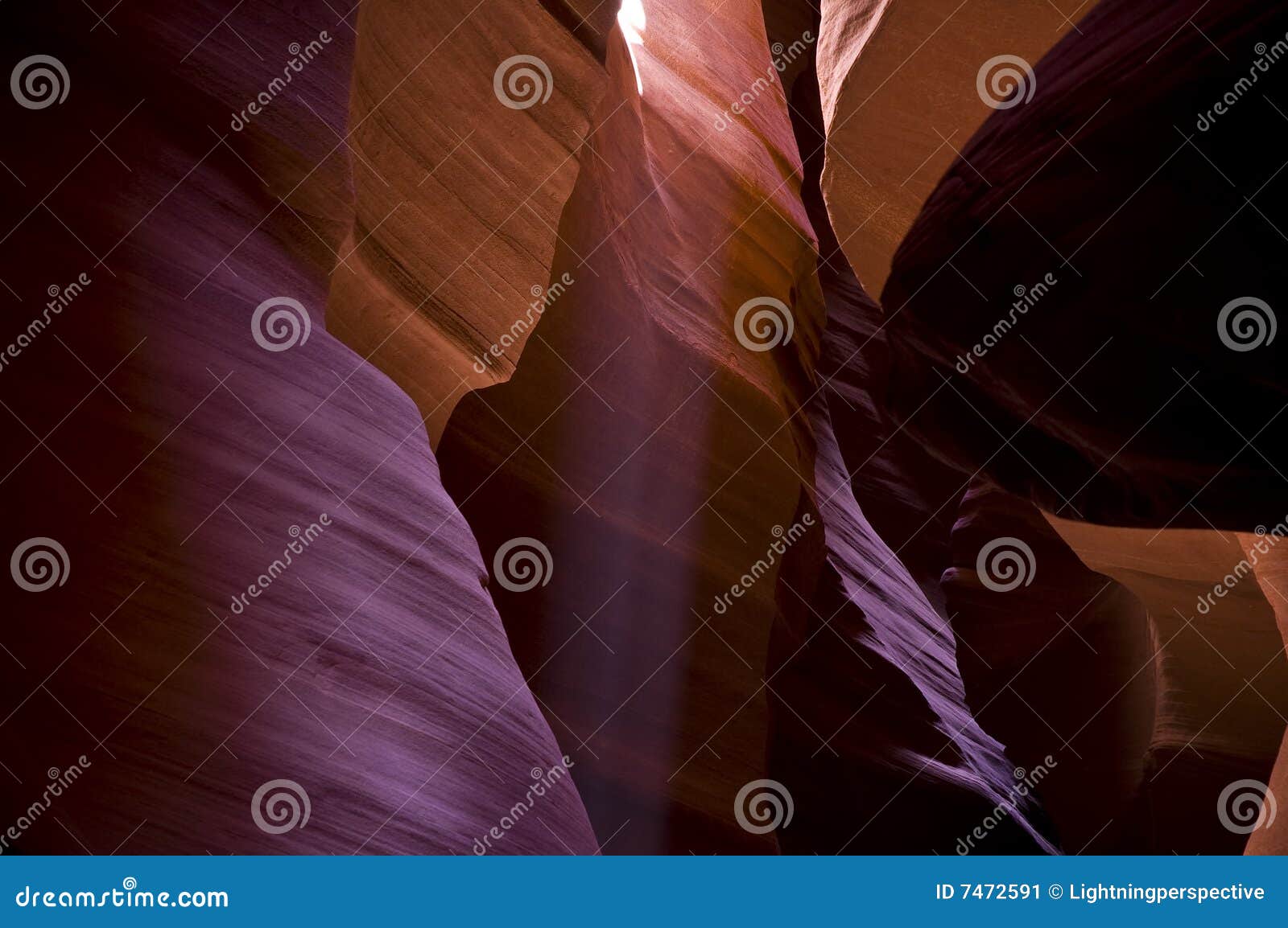 Antelope Canyon light beams. Beautiful slot canyon in Page Arizona right next to Lake Powell. This Canyon is formed by flash flooding and the open top allows for beautiful light from the sun to beam down onto the sandy floor.