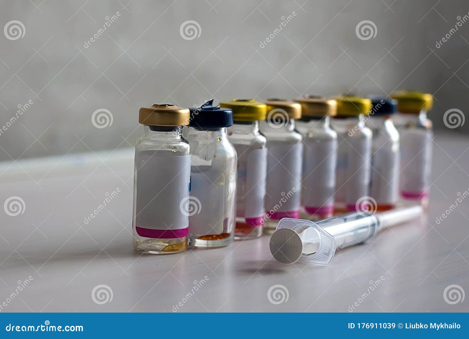 Antibiotic Bottles are on a White Table with a Syringe Stock Image