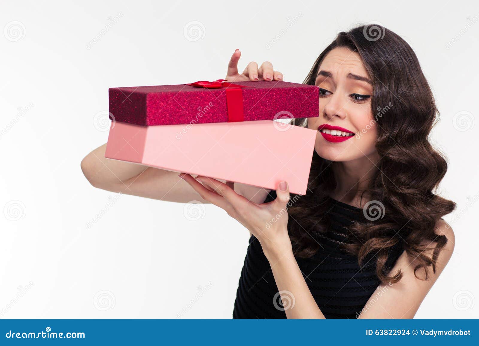 anticipated attractive curly woman in retro style opening present box