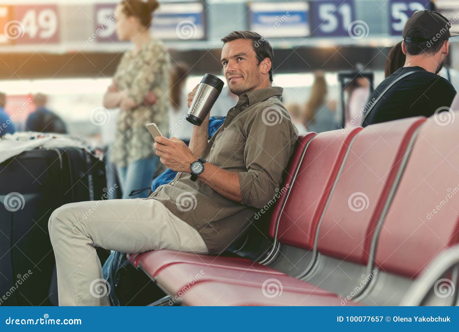 joyful male is waiting for his flight