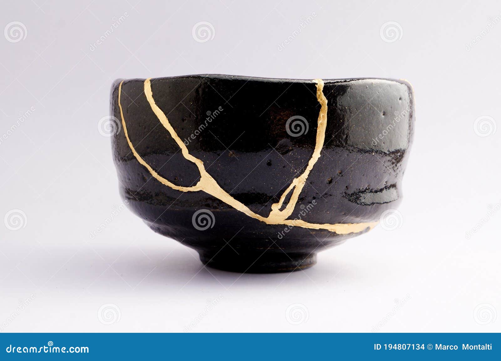 antique beautiful broken raku bowl restored with kintsugi gold technique