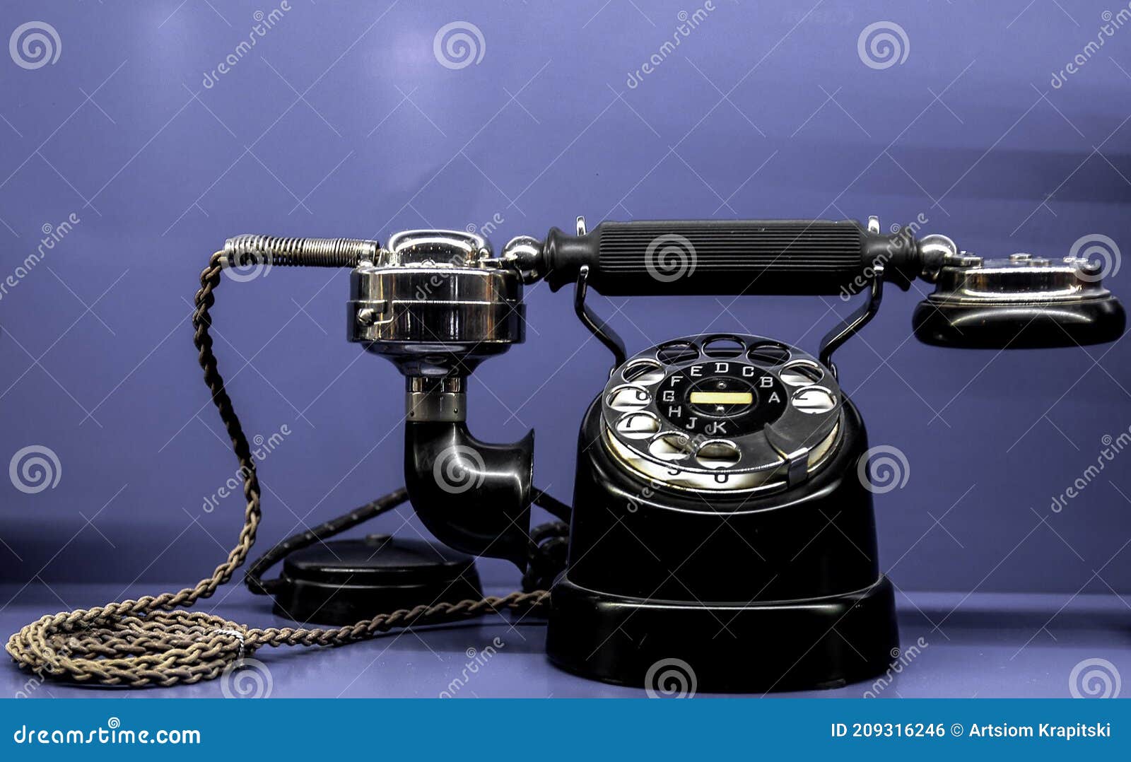 Antique, Black Phone with Letters on the Disk. Old Telephone on a Blue ...