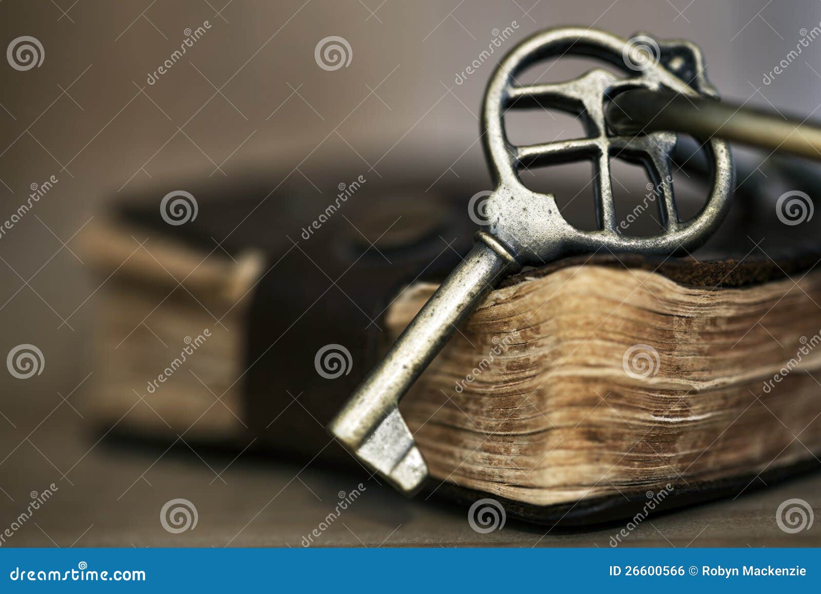 Antique Brass Key on Old Book. Antique brass key on old leather-bound book. Shallow depth of field.