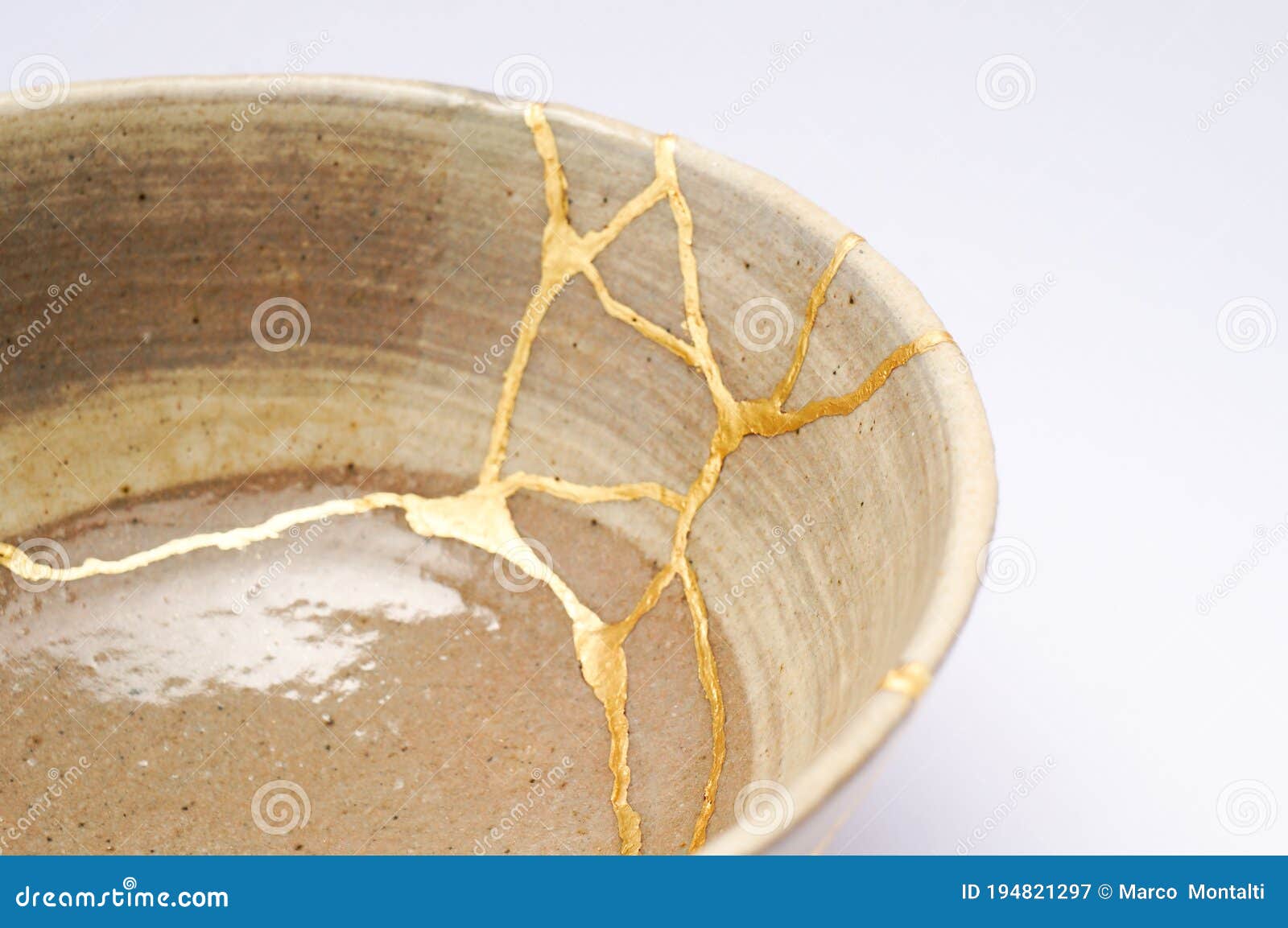 antique broken bowl repaired with gold kintsugi technique