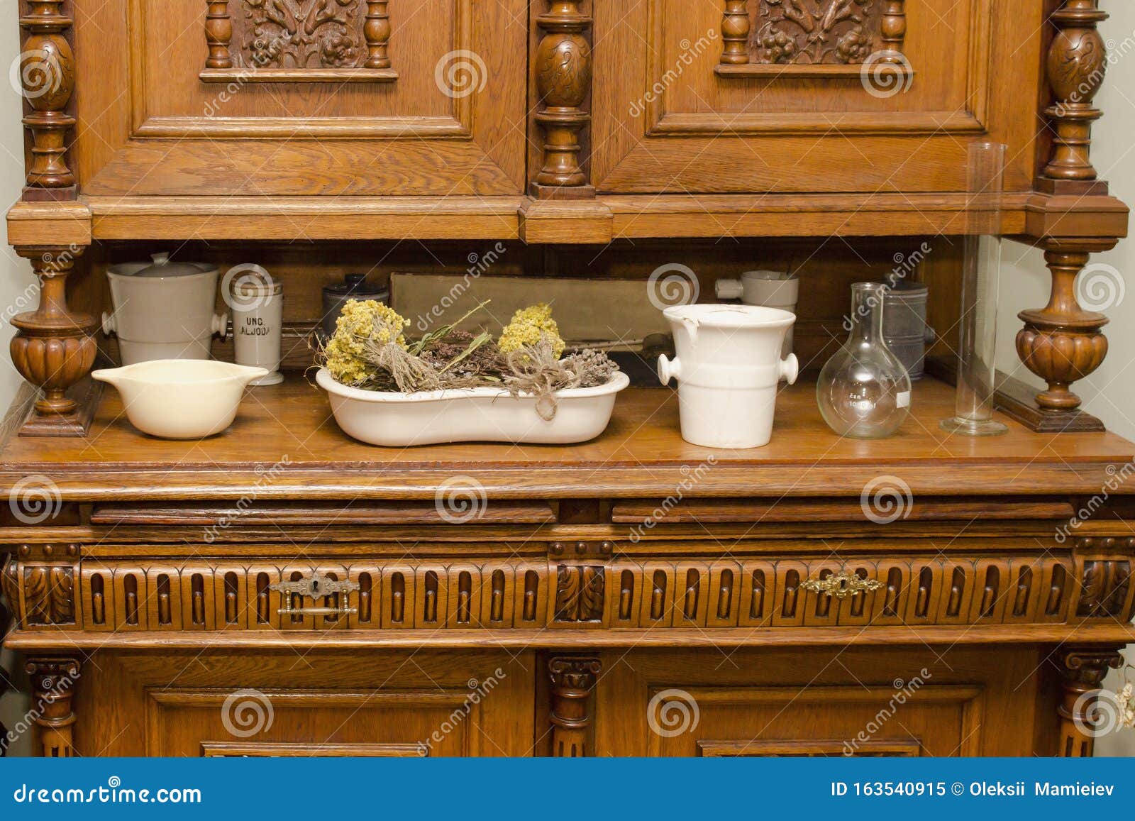 Antique Chemist Ware And Dried Herbs On The Top Of The Wooden