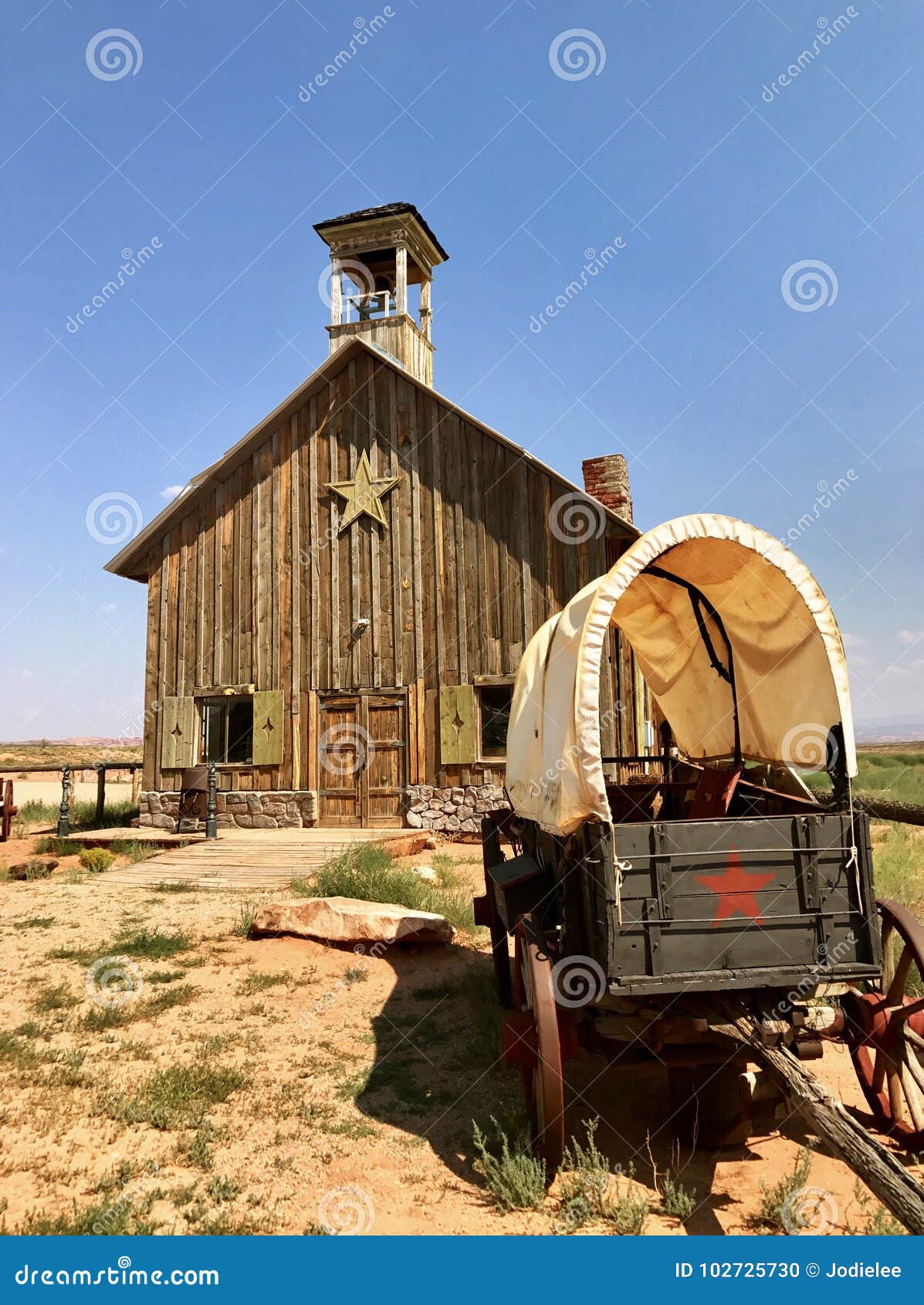 antique covered wagon and settler church in watercolor