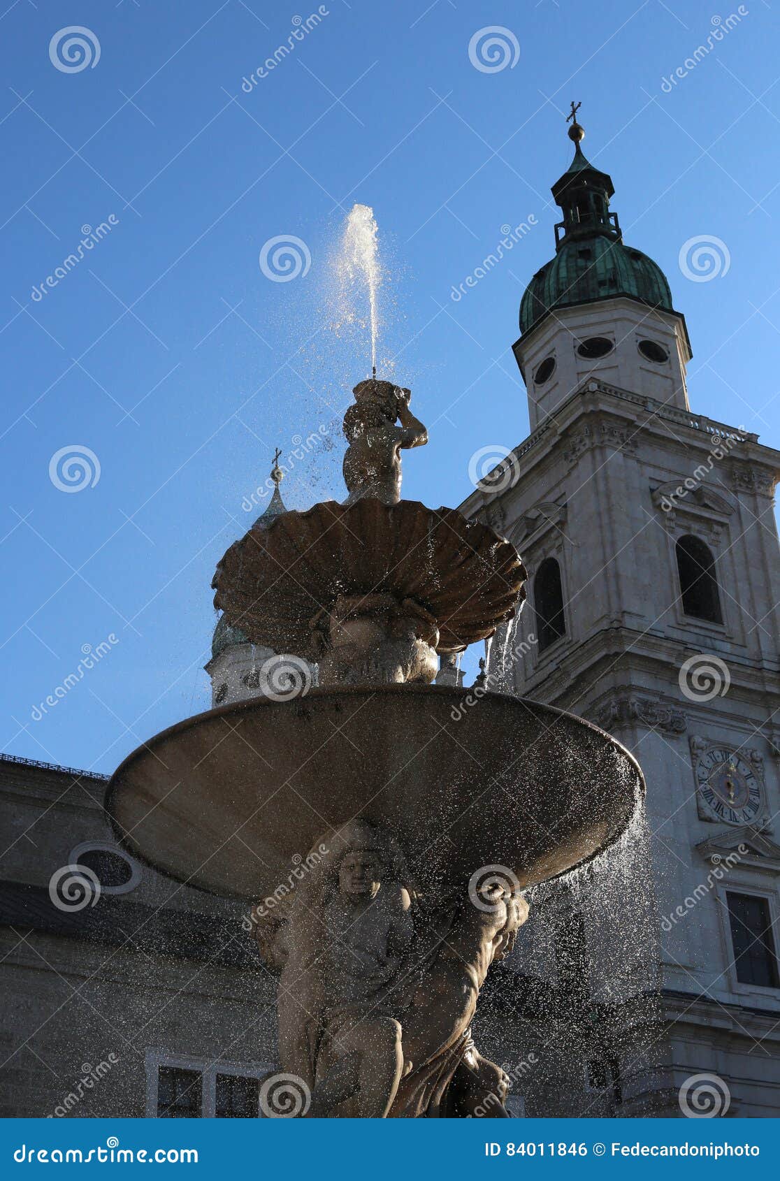 antique fountain with water in the main square of the city of sa