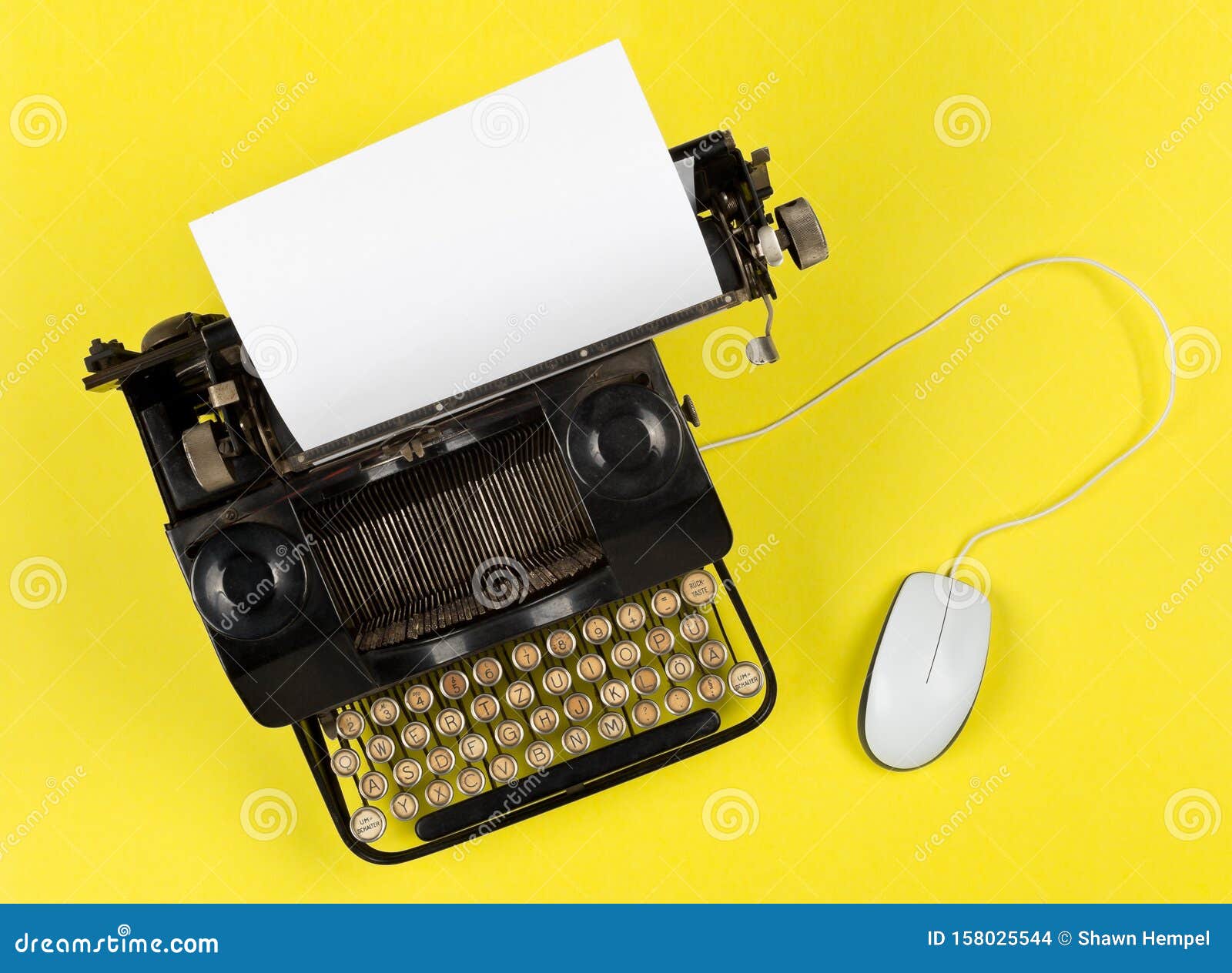 antique retro mechanical typewriter with modern computer mouse on yellow background - digitalization, digitization or