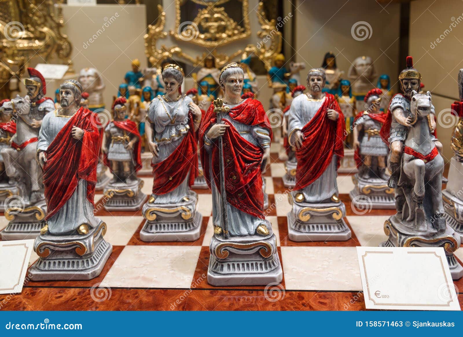 antique roman figure chess set for sale displayed in an antiquities shop window