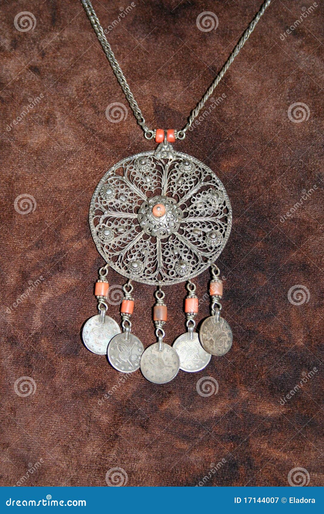 Antique silver jewellery, necklace on brown background