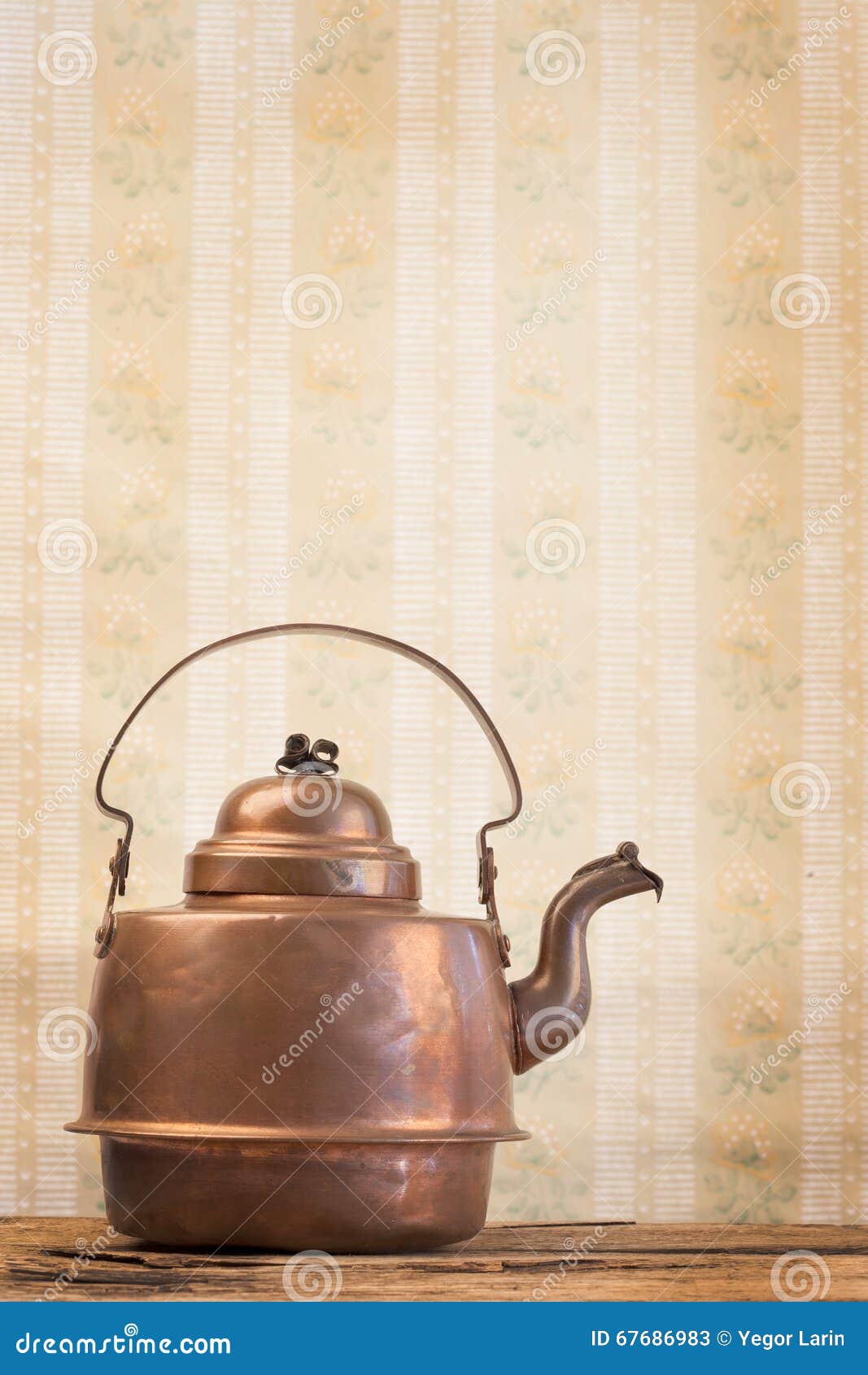 Antique Vintage Copper Kettle on the Background of Old Wallpaper Stock