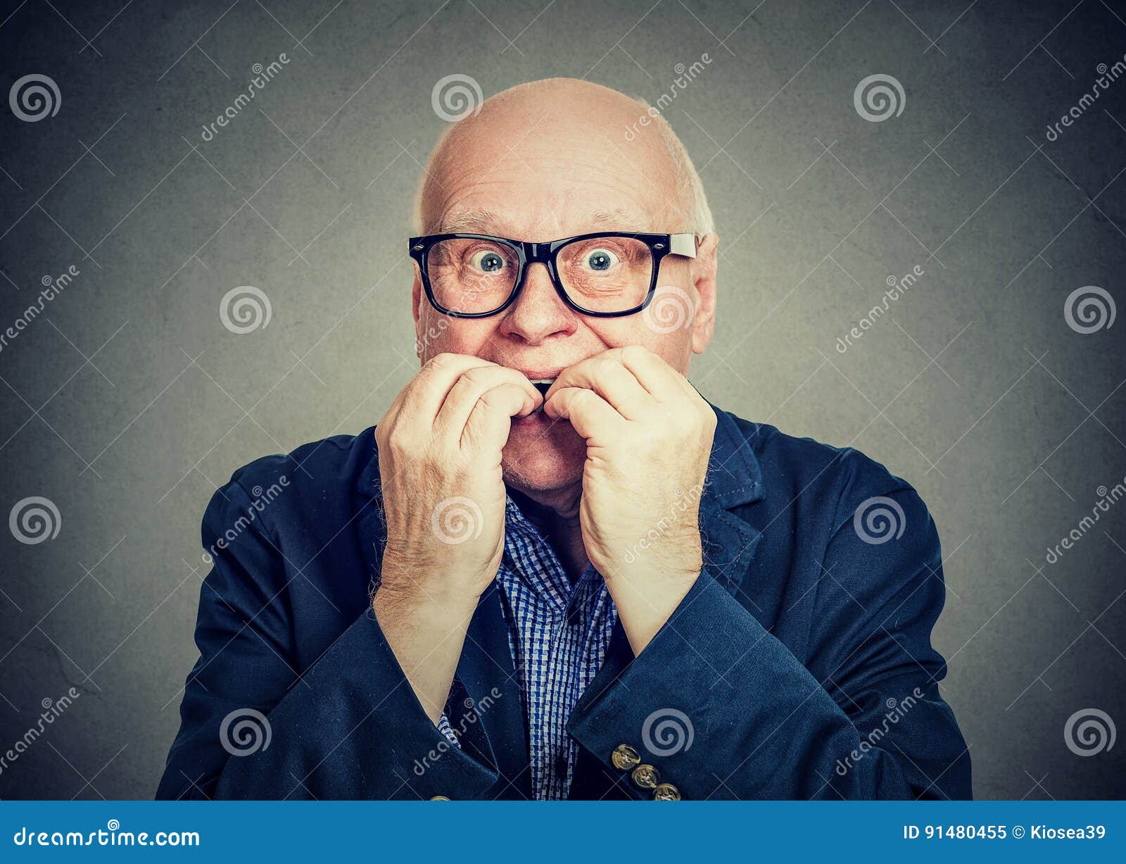 anxious scared senior man biting fingernails