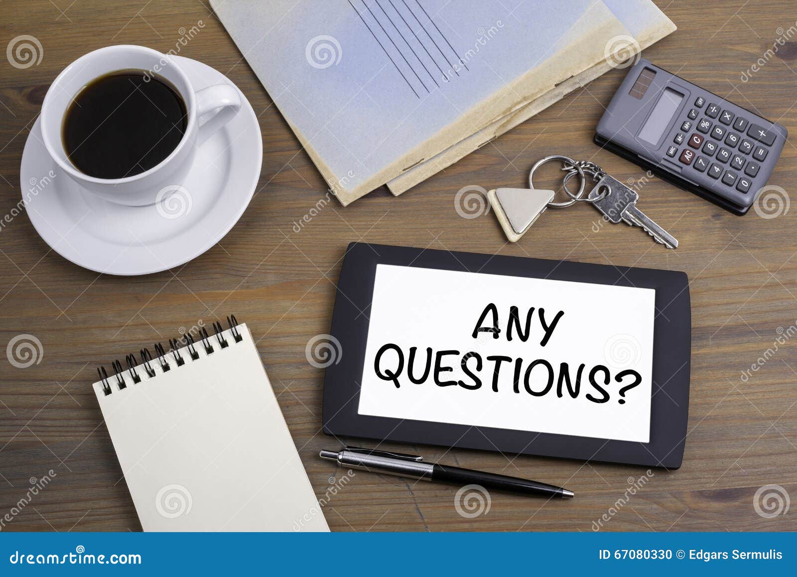 any questions? text on tablet device on a wooden table