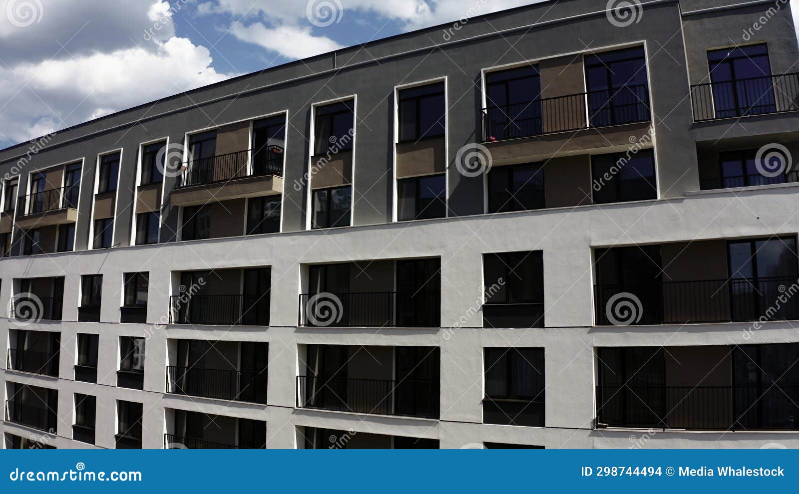 apartment blocks with balconies. stock footage. aerial view of an apartment building on a blue cloudy sky background.