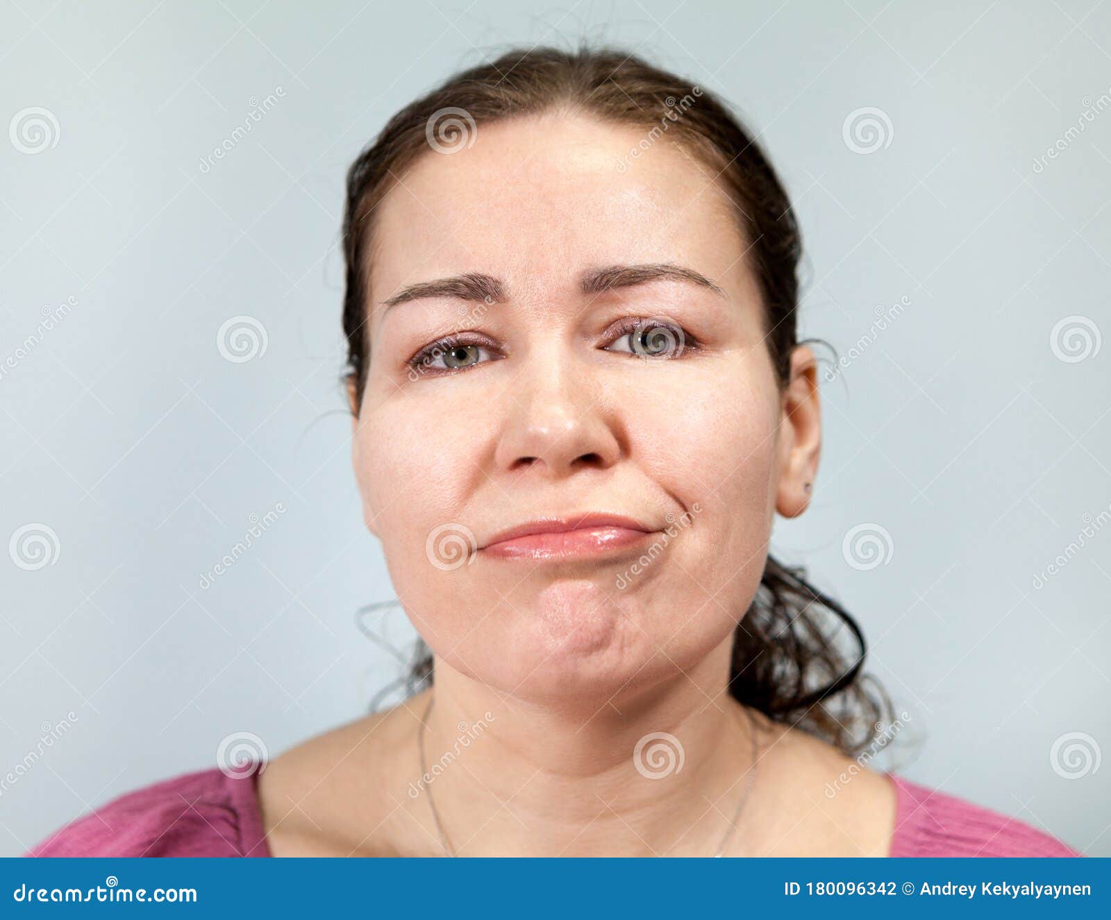 apathy and laziness on the face of an adult woman, portrait on grey background, emotions series