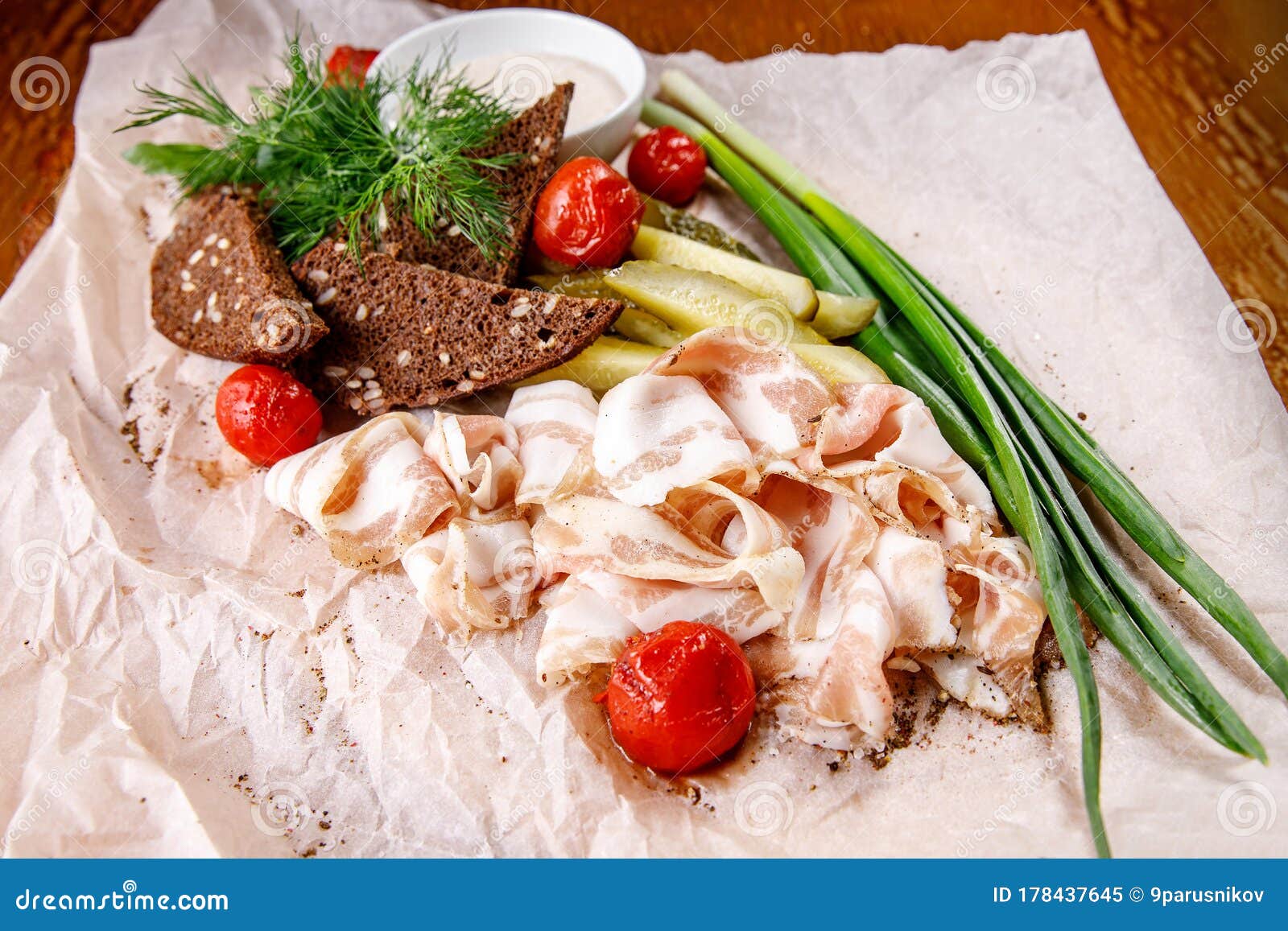 Appetizer of Lard, Horseradish, Crackers, and Pickles on a Napkin Stock