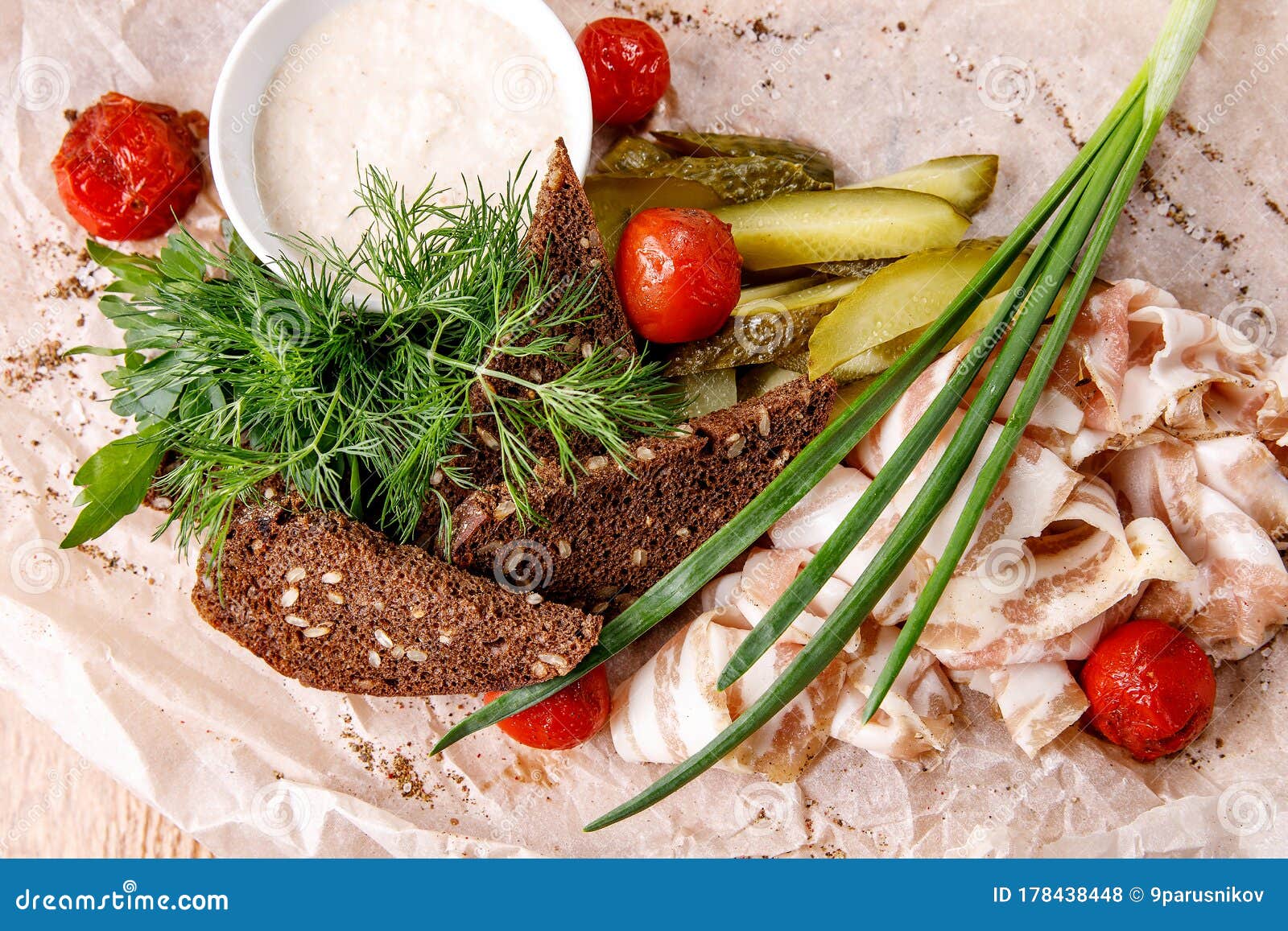 Appetizer of Lard, Horseradish, Crackers, and Pickles on a Napkin Stock