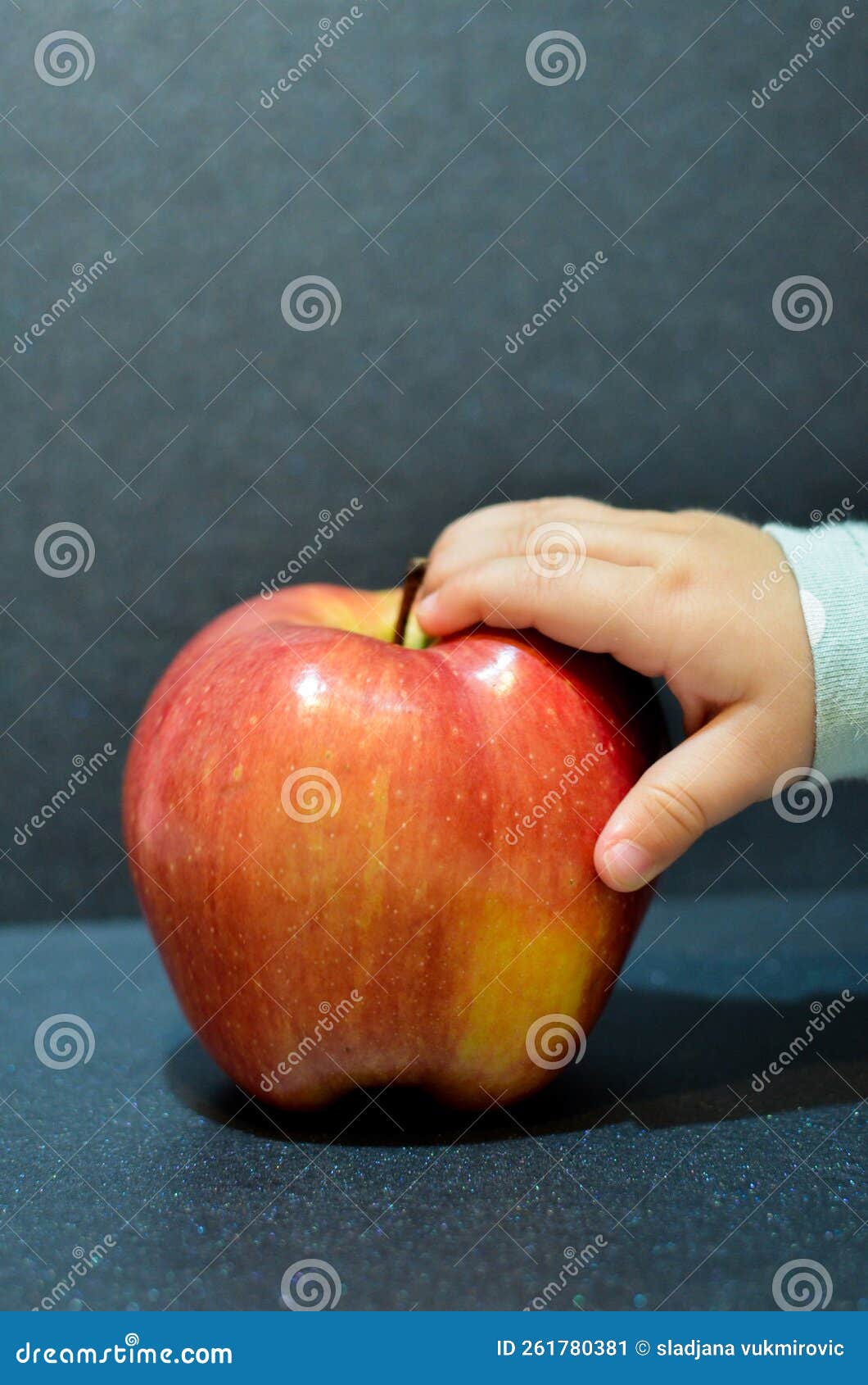 Apple with babies hand stock image. Image of yellow 261780381