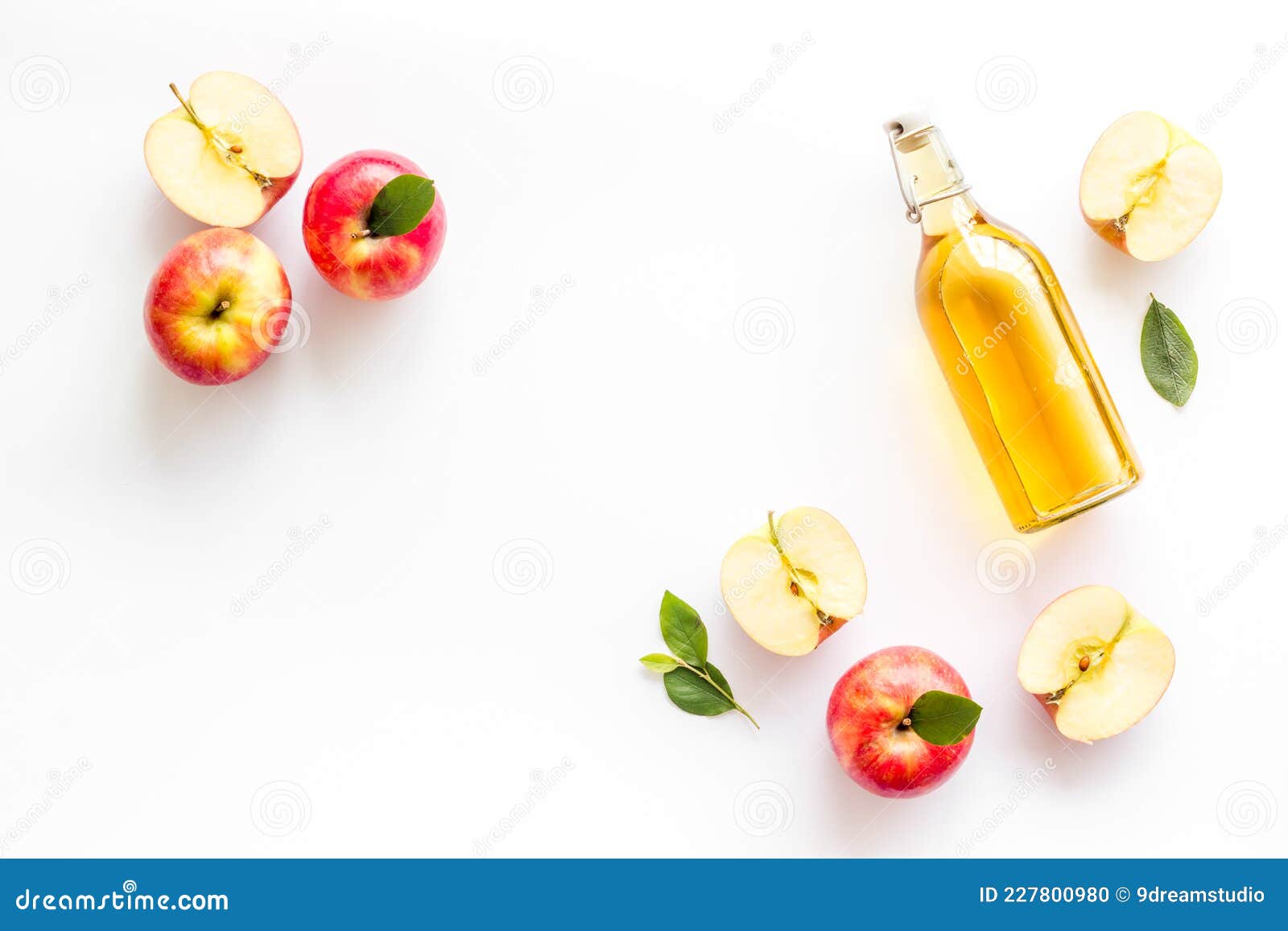 Apple Cider Vinegar in Glass Bottle with Fresh Red Apples Stock Photo