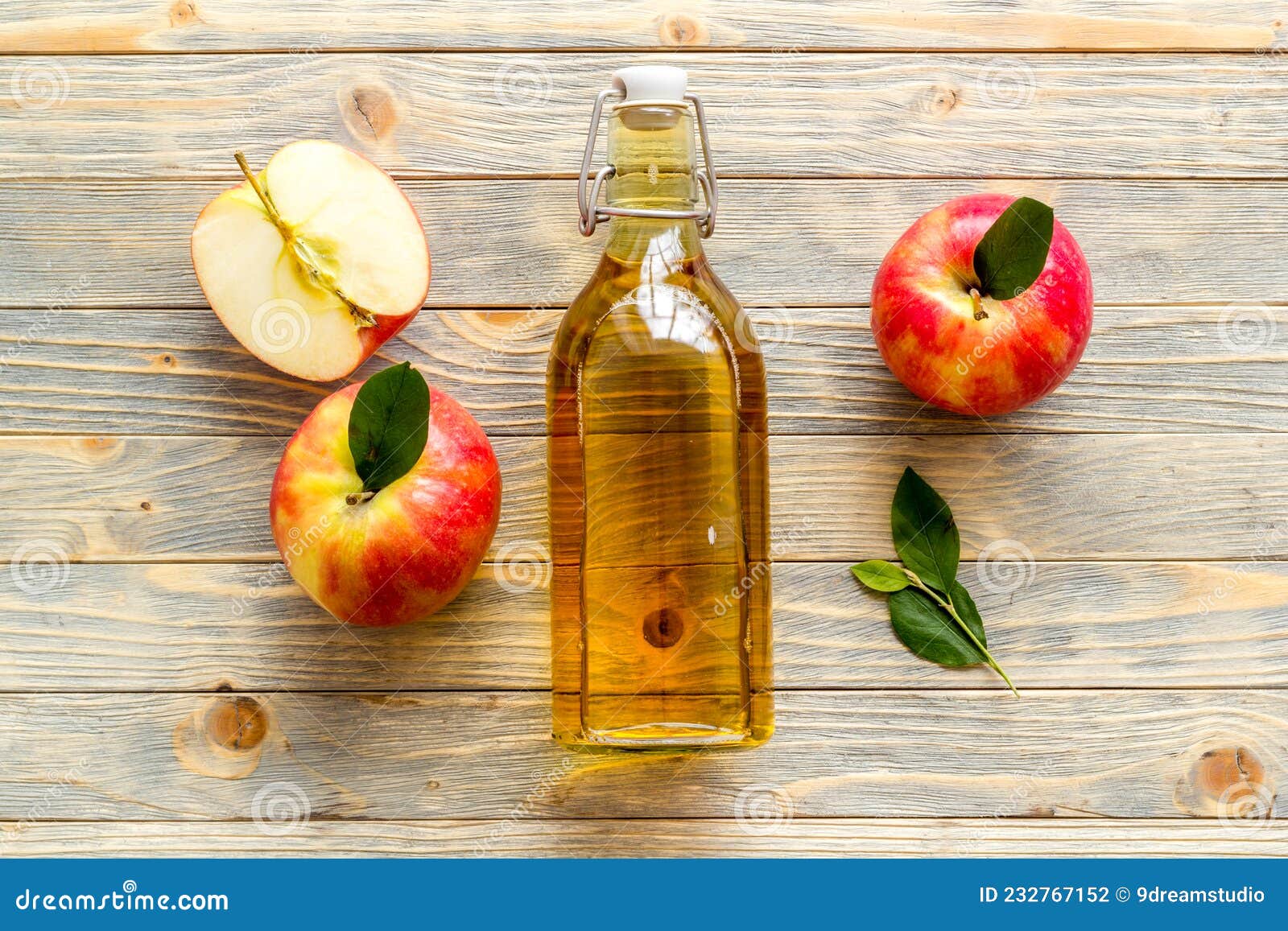 Apple Cider Vinegar in Glass Bottle with Fresh Red Apples Stock Photo